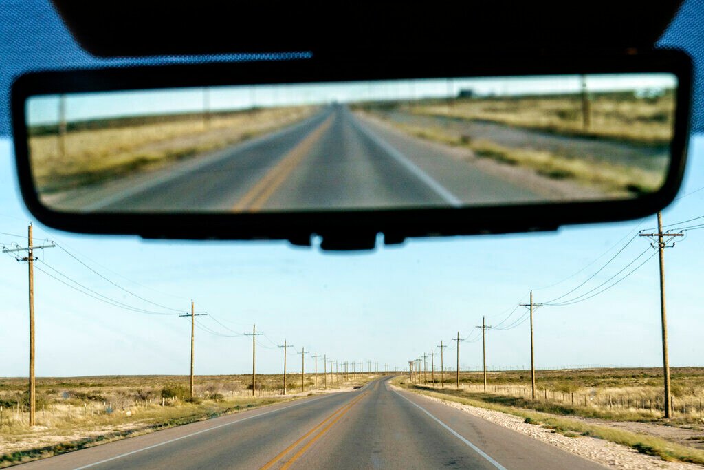 <p>Utility poles line a road through the Permian Basin in Mentone, Texas, Thursday, Oct. 14, 2021. The Permian, a 250-mile-wide bone-dry expanse along the Texas-New Mexico border, was the bottom of a shallow sea a billion years ago. </p>