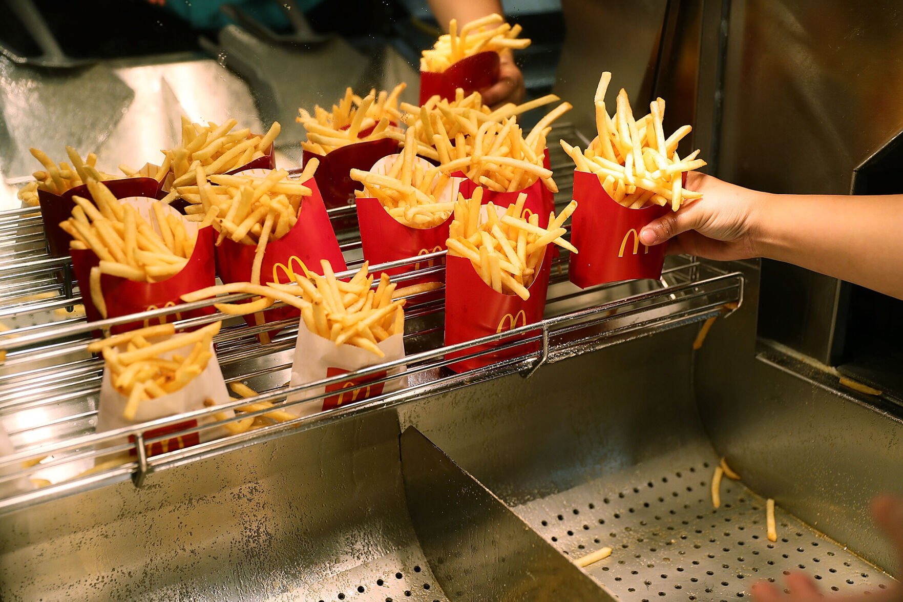 <p>McDonald's and Wendy's are both giving away free fries this week. A McDonald's crew member prepares french fries at a McDonald's restaurant on April 25, 2017 in Miami, Florida.</p>