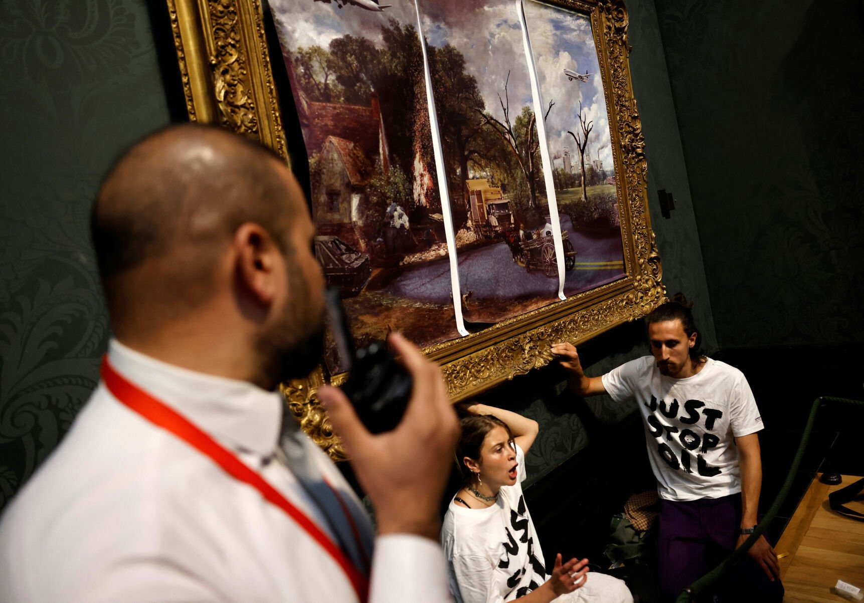 <p>Activists glued their hands to the frame of "The Hay Wain" after covering it with a mock version of the painting.</p>