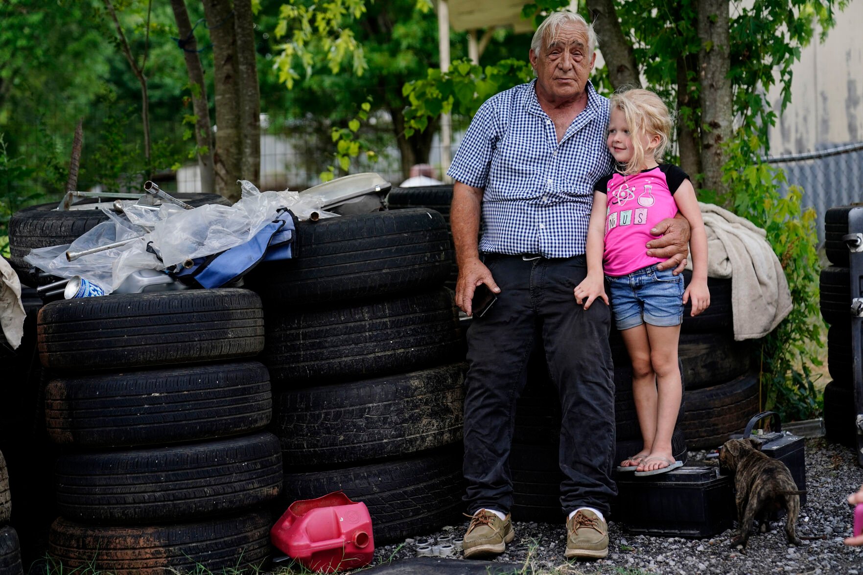 <p>Larry Guess, 72, and his granddaughter Avery Moore, 4, sit outside on some old tires on Thursday, June 23, 2022, in Athens, Ala. </p>