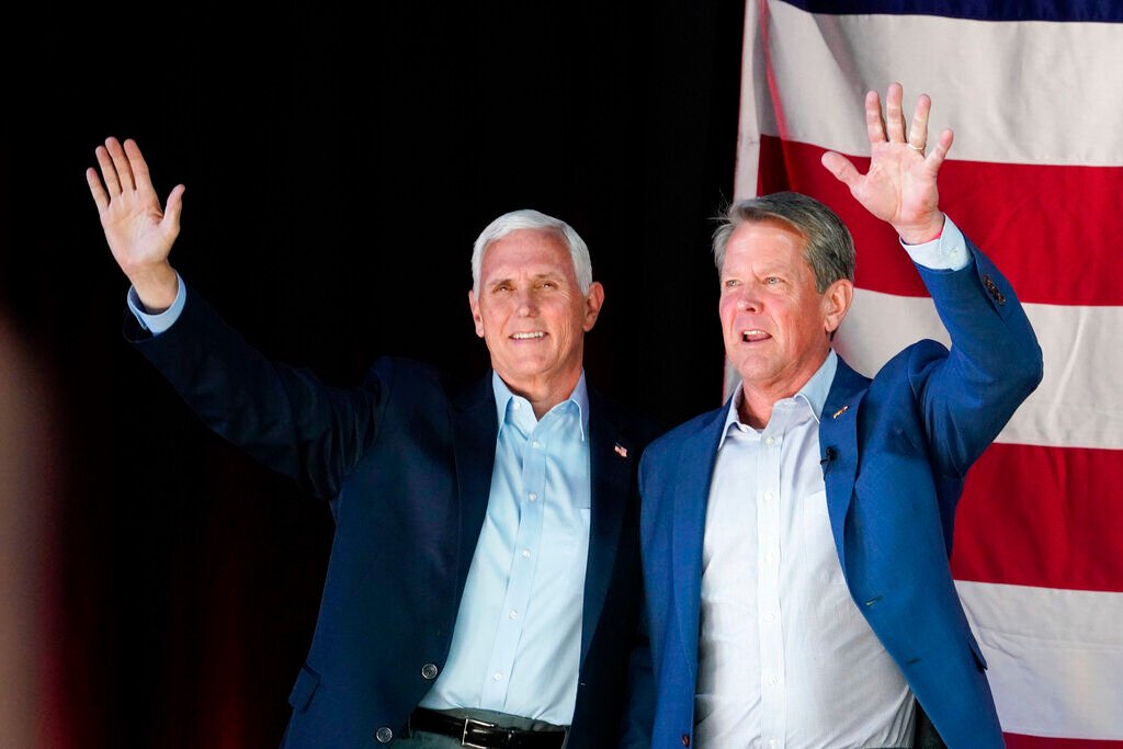 <p>Former Vice President Mike Pence, left, and Georgia Gov. Brian Kemp greet the crowd during a rally, Monday, May 23, 2022, in Kennesaw, Ga. </p>