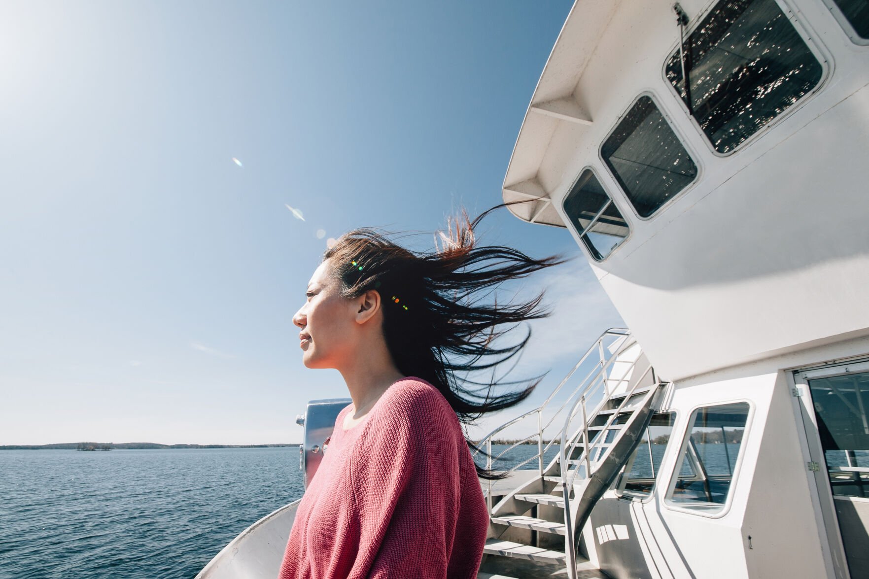 <p>Young woman traveller enjoying the sea and breeze from cruise ship</p>
