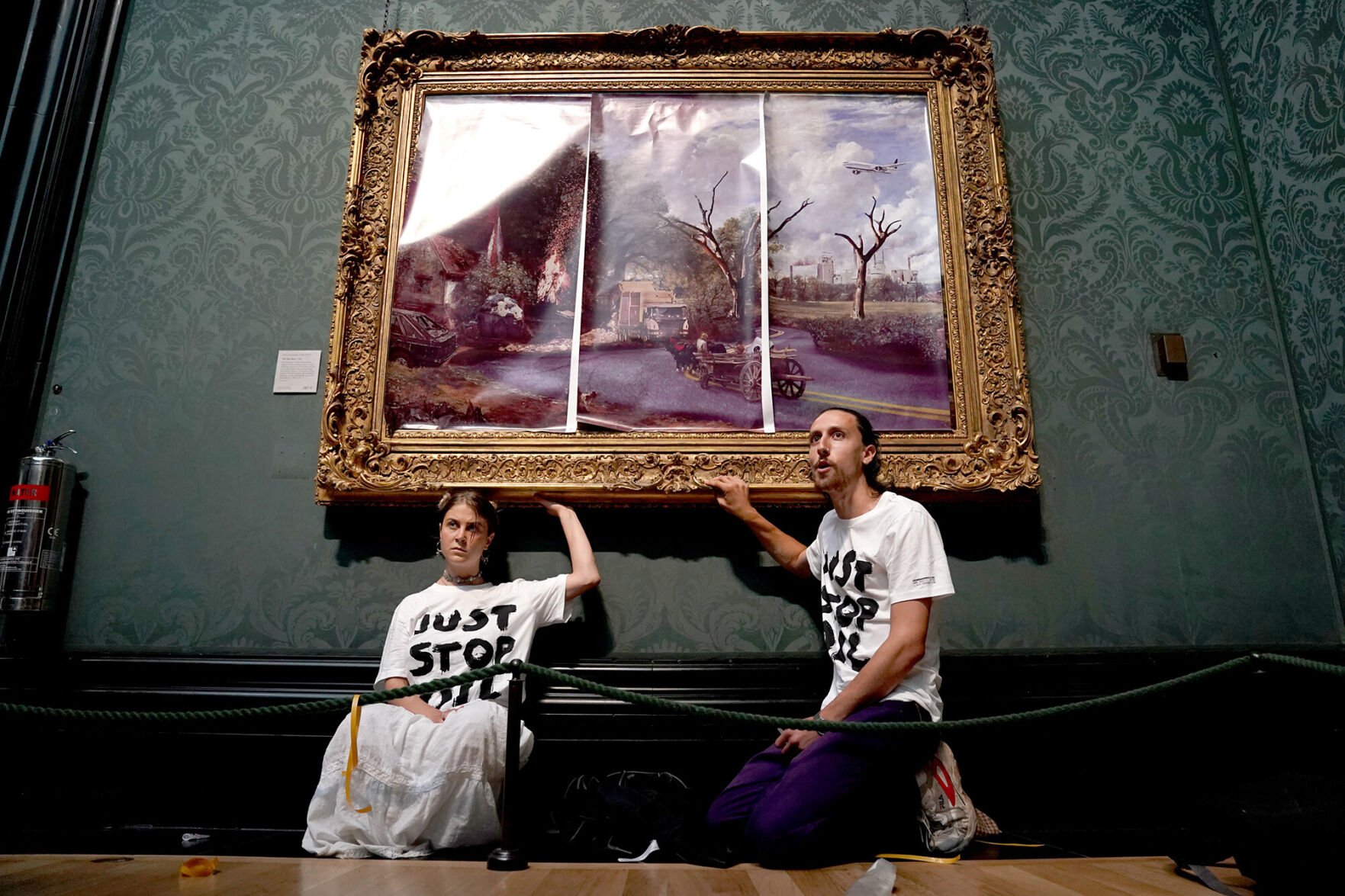 <p>Climate protesters glue themselves to a 200-year-old masterpiece at London's National Gallery on Monday.</p>