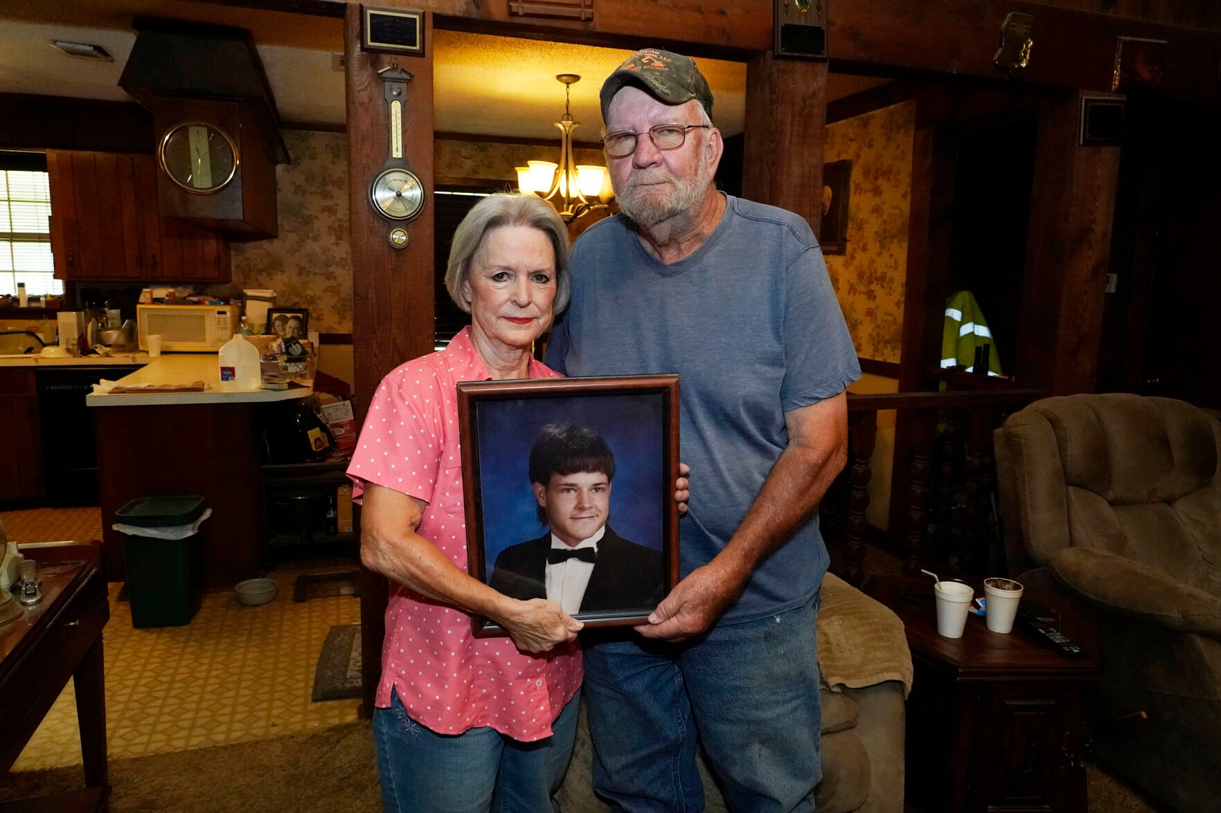 <p>Andrea Breedlove, left, holds a high school portrait of her late son, Chase Brewer, with her husband and Brewer's step-father, Johnny Breedlove, in their home in the Carpenter community near Crystal Springs, Miss., Tuesday, Aug. 9, 2022.</p>