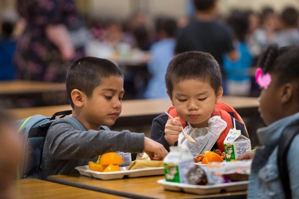 <p>Kindergarten students Alan Corona Olguin, left, and Aidan Chang enjoy a school lunch at an elementary school in Sacramento, Calif., on April 14, 2016.</p>
