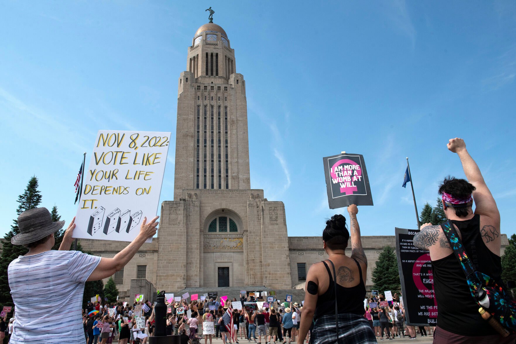 <p>FILE - Protesters line the street around the front of the Nebraska State Capitol during an Abortion Rights Rally held on July 4, 2022, in Lincoln, Neb. A Nebraska woman has been charged in early June with helping her teenage daughter end her pregnancy at about 24 weeks after investigators uncovered Facebook messages in which the two discussed using medication to induce an abortion and plans to burn the fetus afterward.</p>