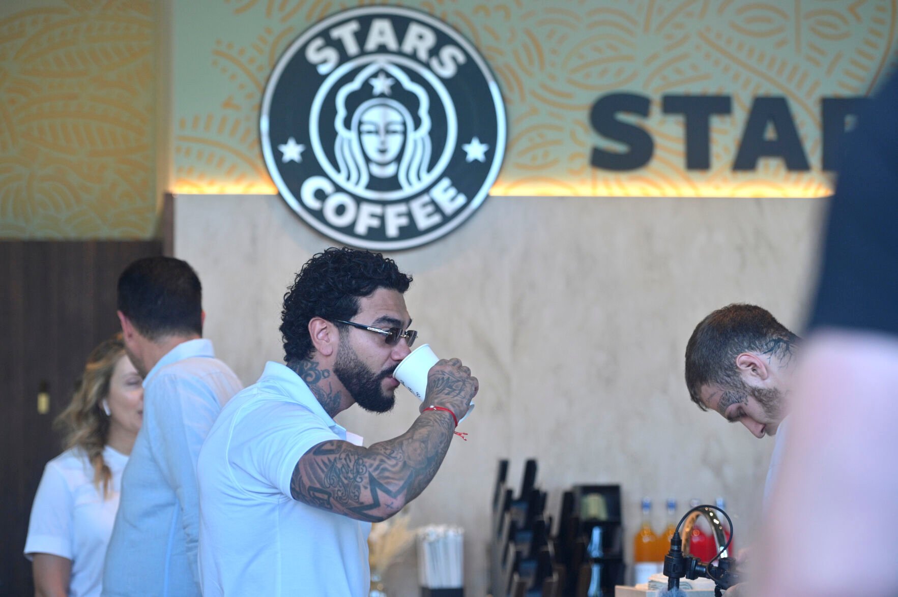<p>Russian singer and entrepreneur Timur Yunusov, better known as Timati, drinks coffee at a newly opened Stars Coffee coffee shop in the former location of the Starbucks coffee shop in Moscow, Russia, Thursday, Aug. 18, 2022. A new chain of coffee shops opens Thursday in Moscow, after Russian singer and entrepreneur Timur Yunusov, better known as Timati, together with Russian restaurateur Anton Pinskiy bought the Starbucks stores following company's withdrawal from Russia. (AP Photo/Dmitry Serebryakov)</p>