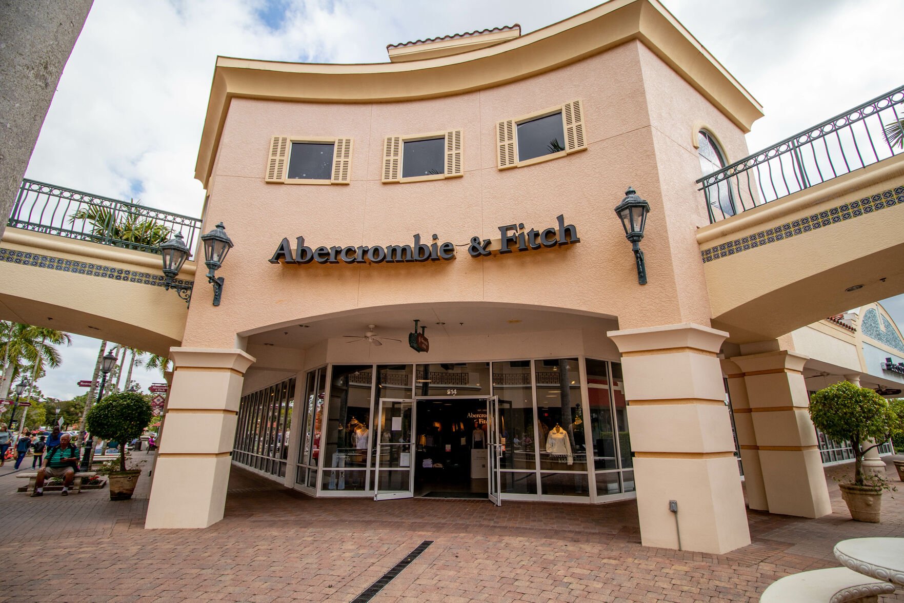 <p>Shoppers walk past the facade of Abercrombie & Fitch Clothing Store in Miromar Outlets as the retailer that focuses on casual wear.</p>