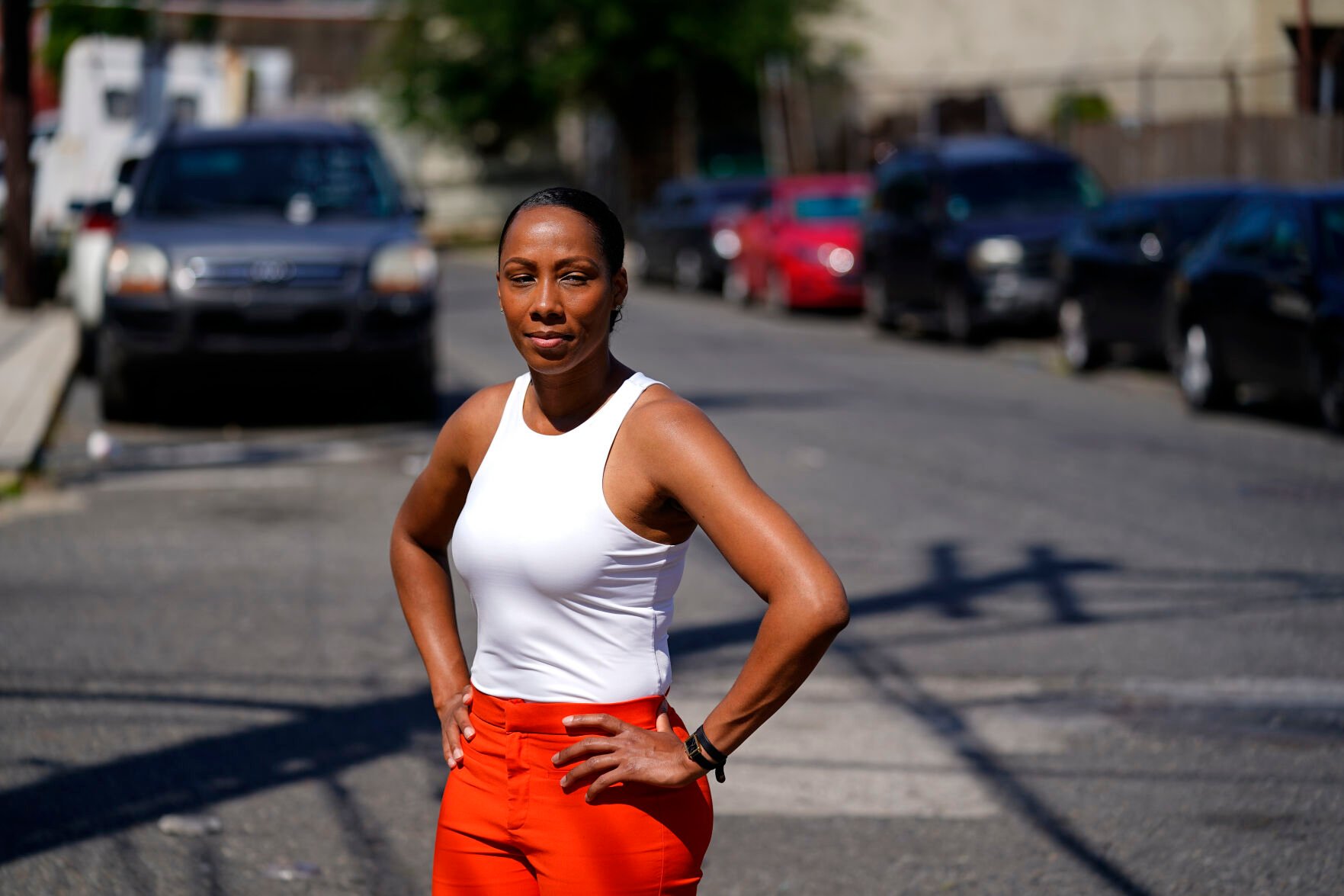<p>Kimberly Washington, executive director of the Frankford Community Development Corporation, and who has worked with community members to address abandoned cars, poses for a portrait on a street frequently used to discard cars in Philadelphia, Thursday, July 14, 2022. </p>