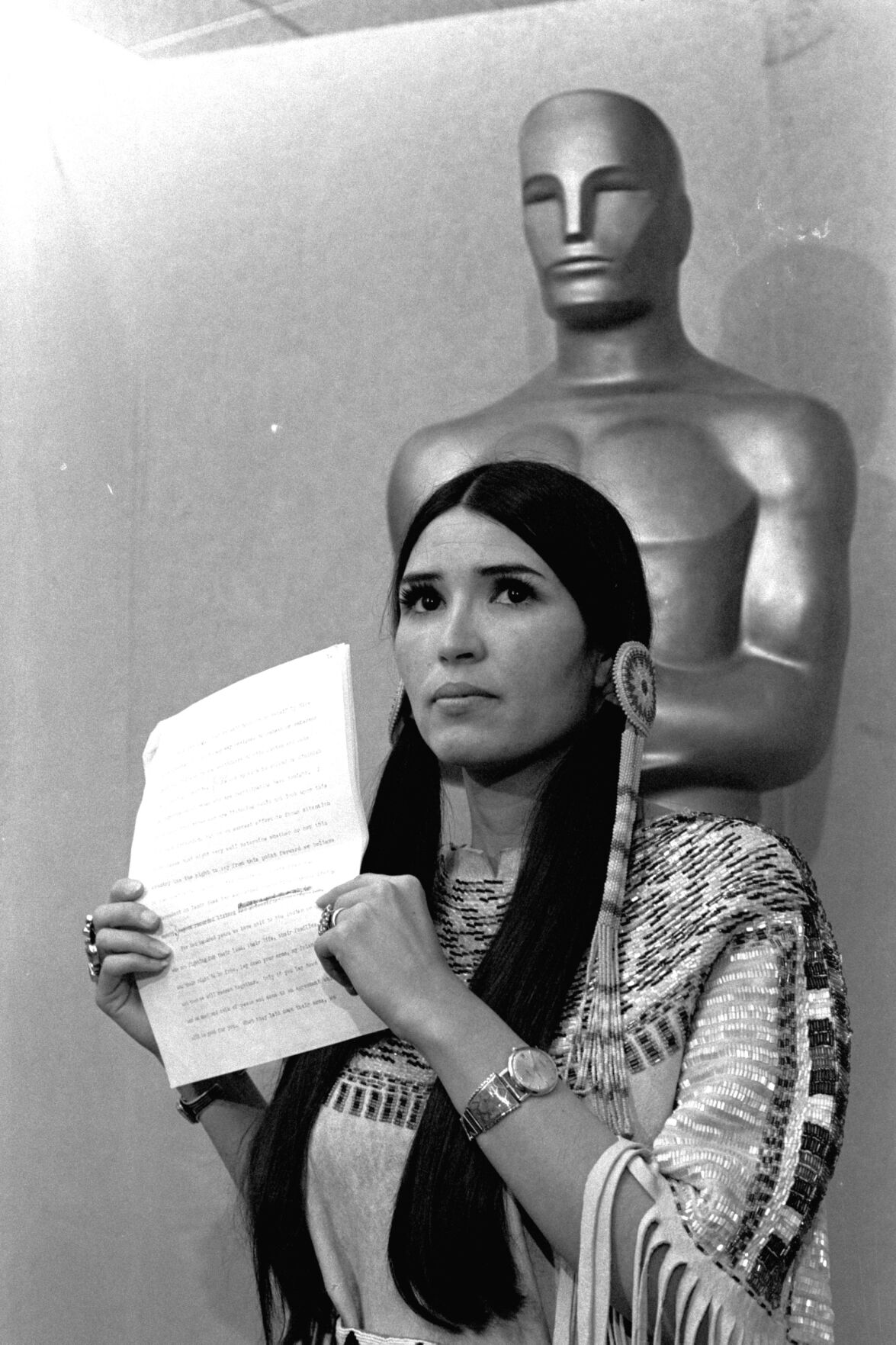 <p>FILE - In this March 27, 1973 file photo, Sacheen Littlefeather, tells the audience at the Academy Awards ceremony that Marlon Brando was declining to accept his Oscar as best actor for his role in "The Godfather."</p>