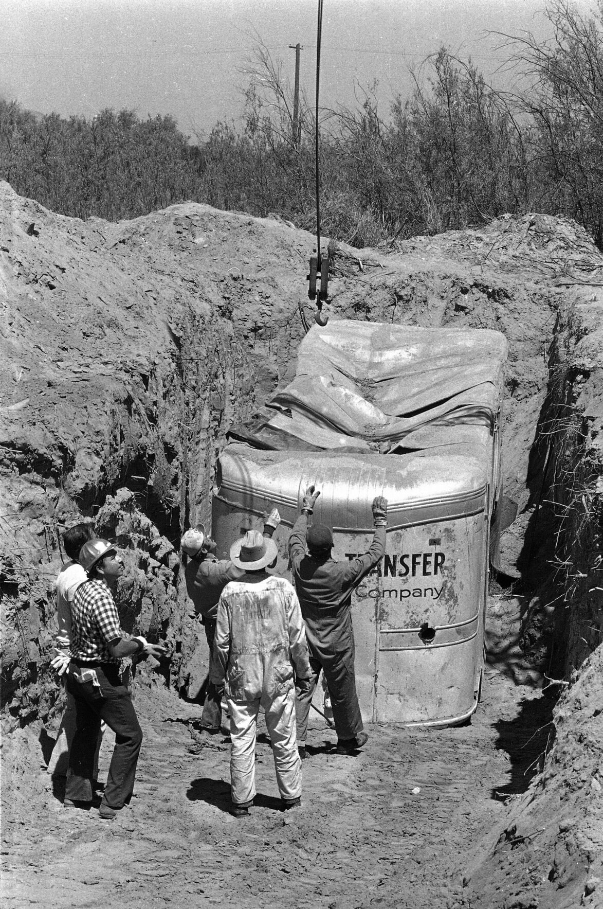<p>FILE - In this July 20, 1976, photo, officials remove a moving van buried at a rock quarry in Livermore, Calif., in which 26 Chowchilla school children and their bus driver, Ed Ray were held captive. </p>