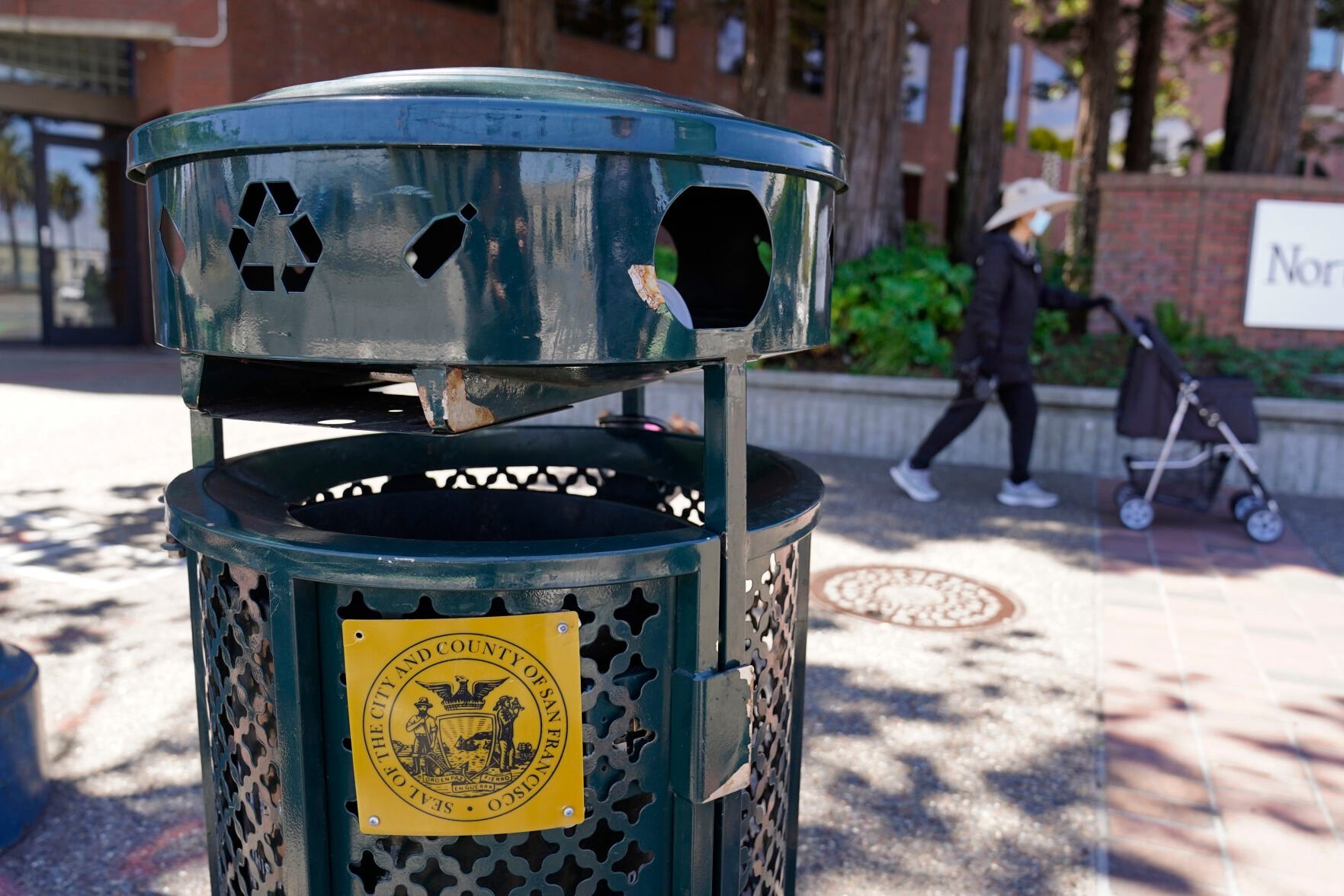 <p>A woman walks past a Renaissance trash can that has been used for nearly 20 years in San Francisco, on July 26, 2022. As a replacement for the Renaissance trash can, city officials have deployed custom-made trash cans that took more than 3 years to design and produce, including one prototype that cost taxpayers more than ,000. Now they are asking residents for feedback. (AP Photo/Eric Risberg)</p>