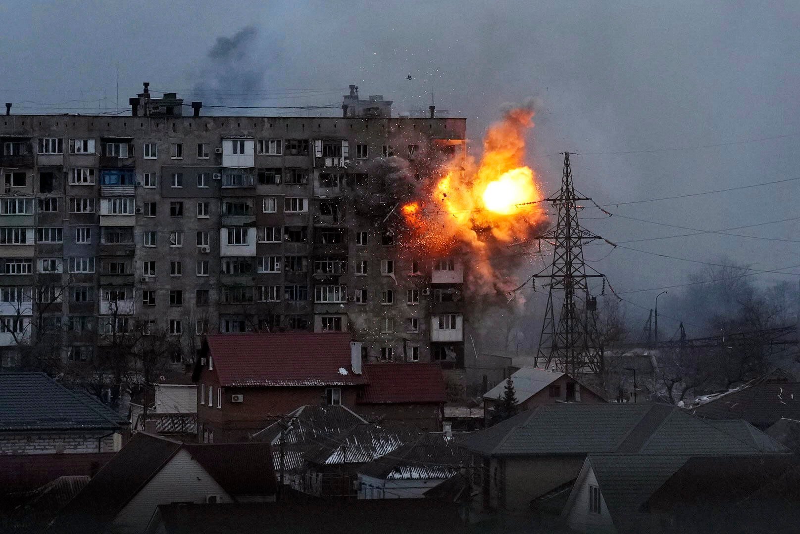 <p>FILE - An explosion is seen in an apartment building after Russian's army tank fires in Mariupol, Ukraine, March 11, 2022. </p>