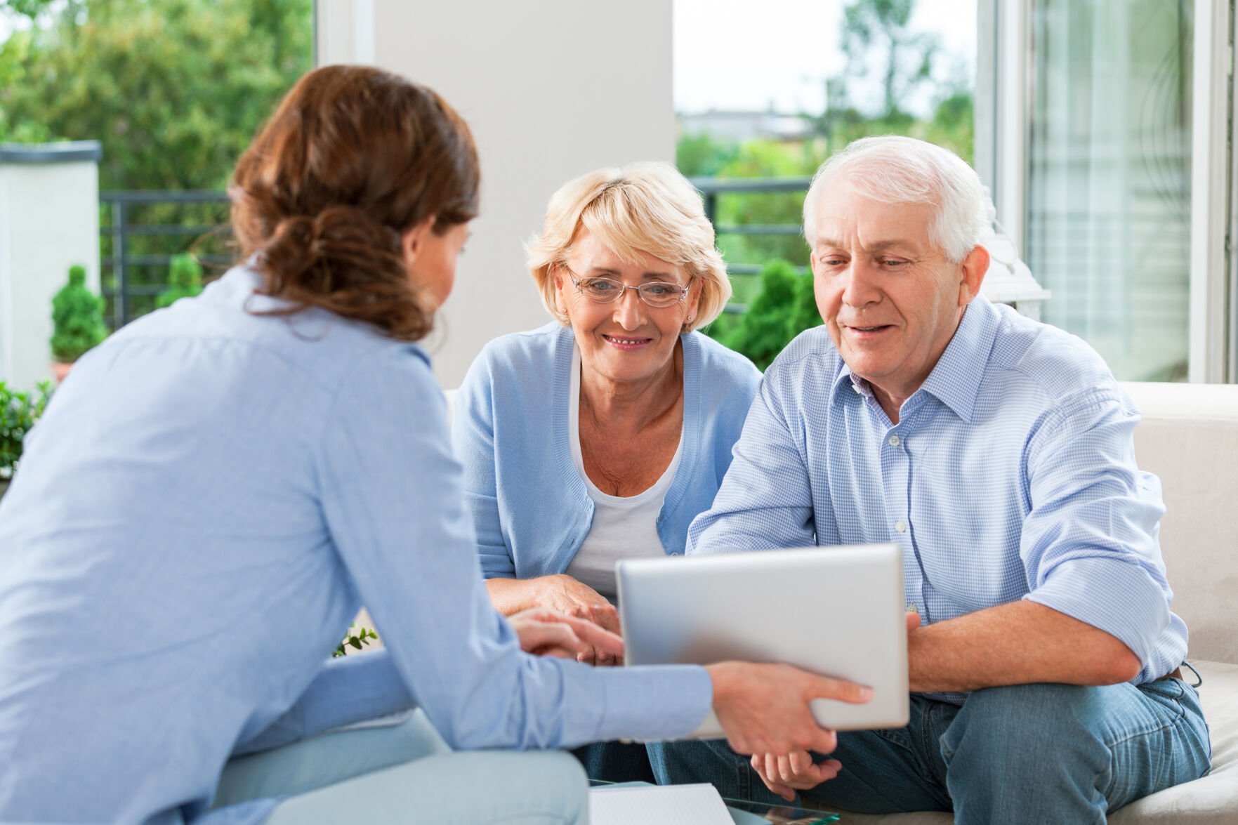 <p>Senior couple having meeting with financial advisor or insurance agent at home.</p>