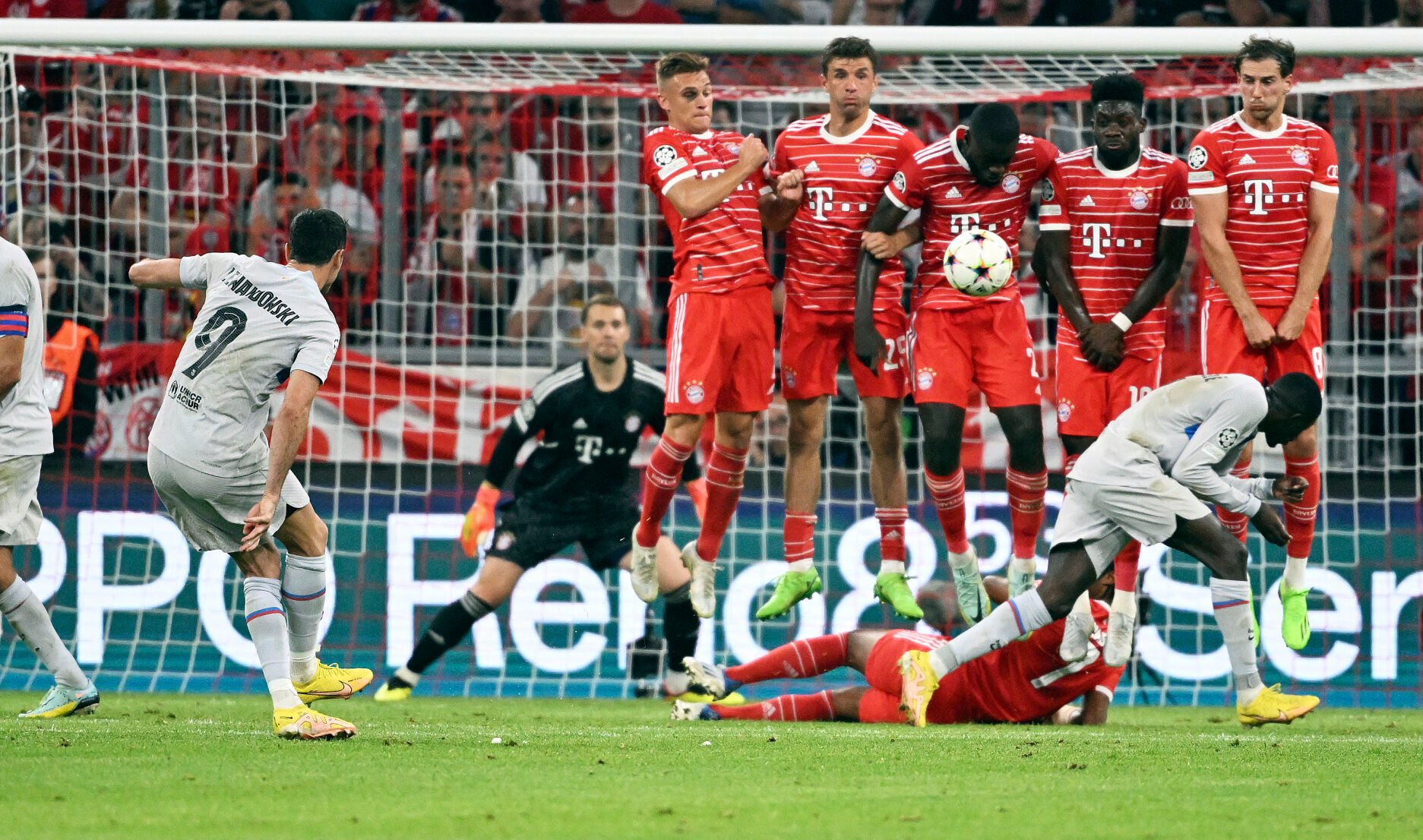 <p>Barcelona's Robert Lewandowski (9) shoots a free kick against Munich during a Champions League, group C soccer match between Bayern Munich and Barcelona at the Allianz Arena in Munich, Germany, Tuesday, Sept. 13, 2022.</p>