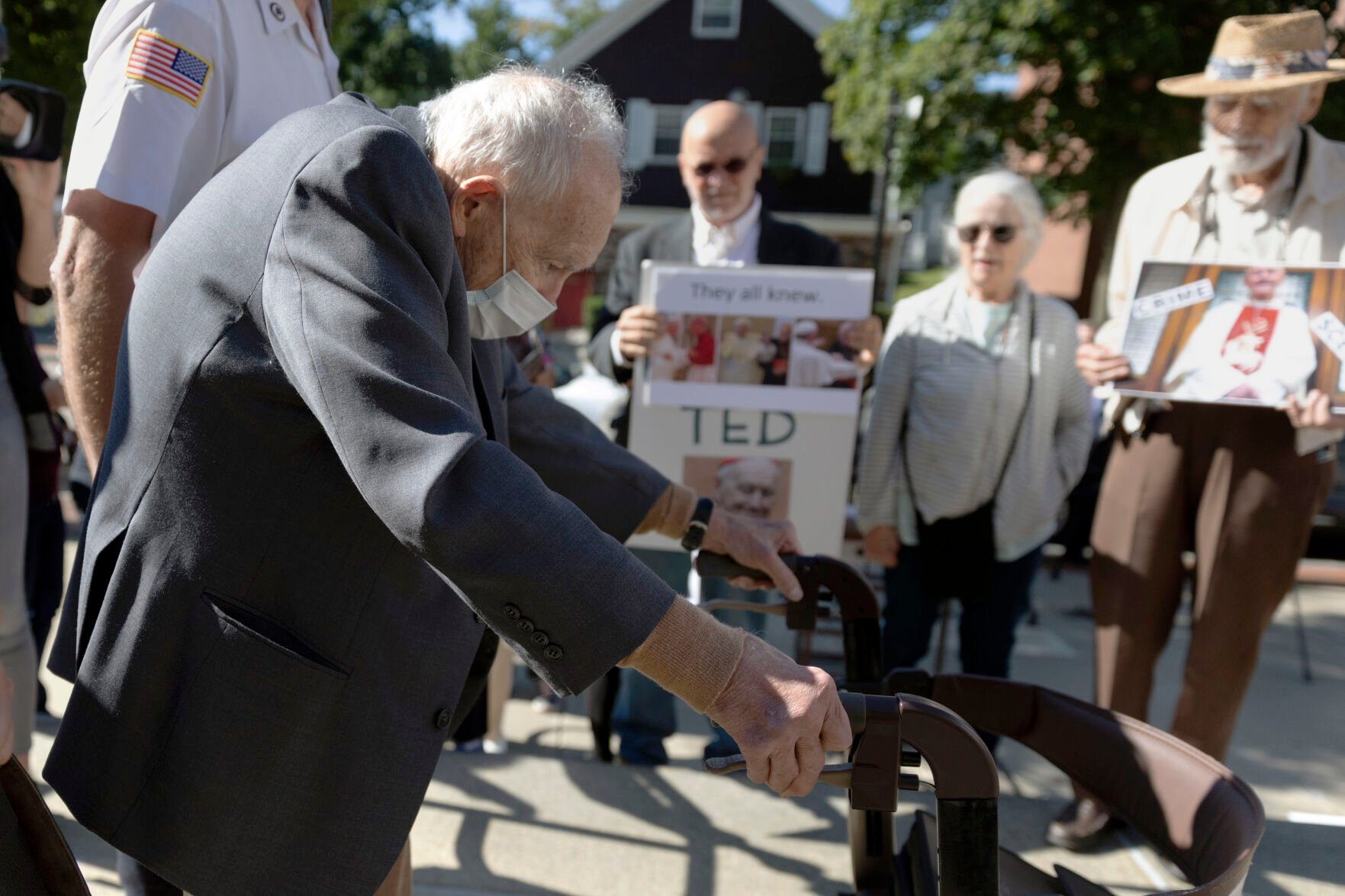 <p>FILE - Demonstrators watch as former Cardinal Theodore McCarrick leaves Dedham District Court after his arraignment, Friday, Sept. 3, 2021, in Dedham, Mass. McCarrick has pleaded not guilty to sexually assaulting a 16-year-old boy during a wedding reception in Massachusetts nearly 50 years ago. (AP Photo/Michael Dwyer, File)</p>