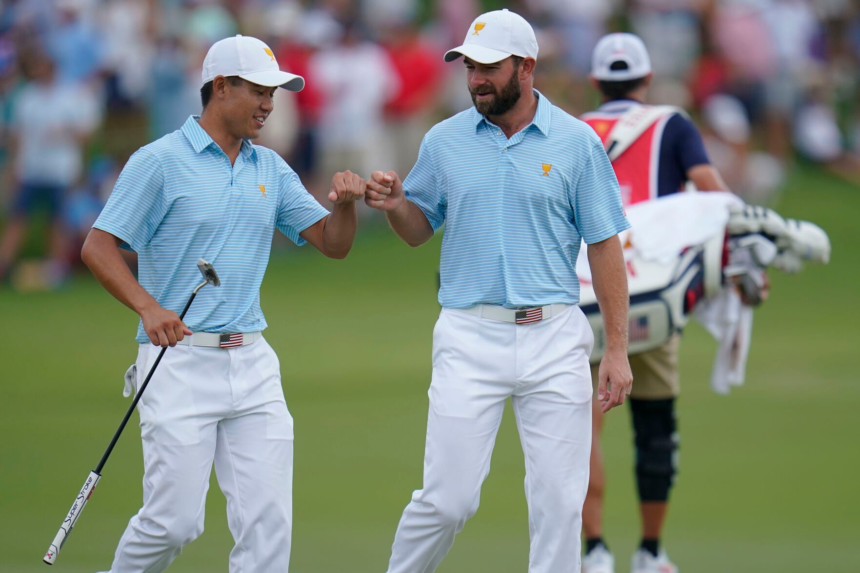 <p>Collin Morikawa, left, and Cameron Young celebrate on the 15th green during their foursomes match at the Presidents Cup golf tournament at the Quail Hollow Club, Thursday, Sept. 22, 2022, in Charlotte, N.C.</p>
