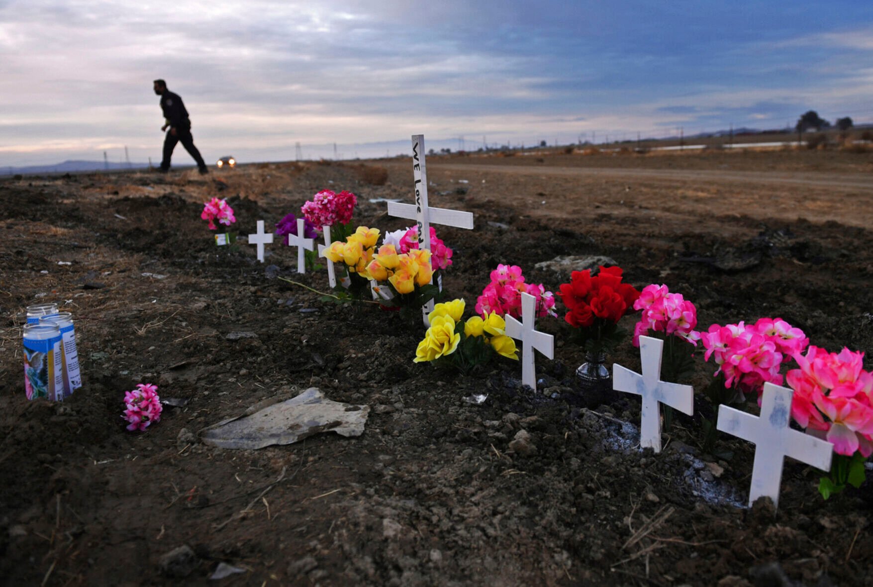 <p>FILE - A row of crosses form a memorial along Highway 33 as police officers survey the scene a day after a crash killed nine people south of Coalinga, Calif., Saturday, Jan. 2, 2021. Investigators said the driver of an SUV involved in the crash was drunk and didn't have a license. The National Transportation Safety Board will use a final report on the crash to launch an effort to lobby for regulations requiring alcohol breath testing devices on all new vehicles. (Eric Paul Zamora/The Fresno Bee via AP)</p>