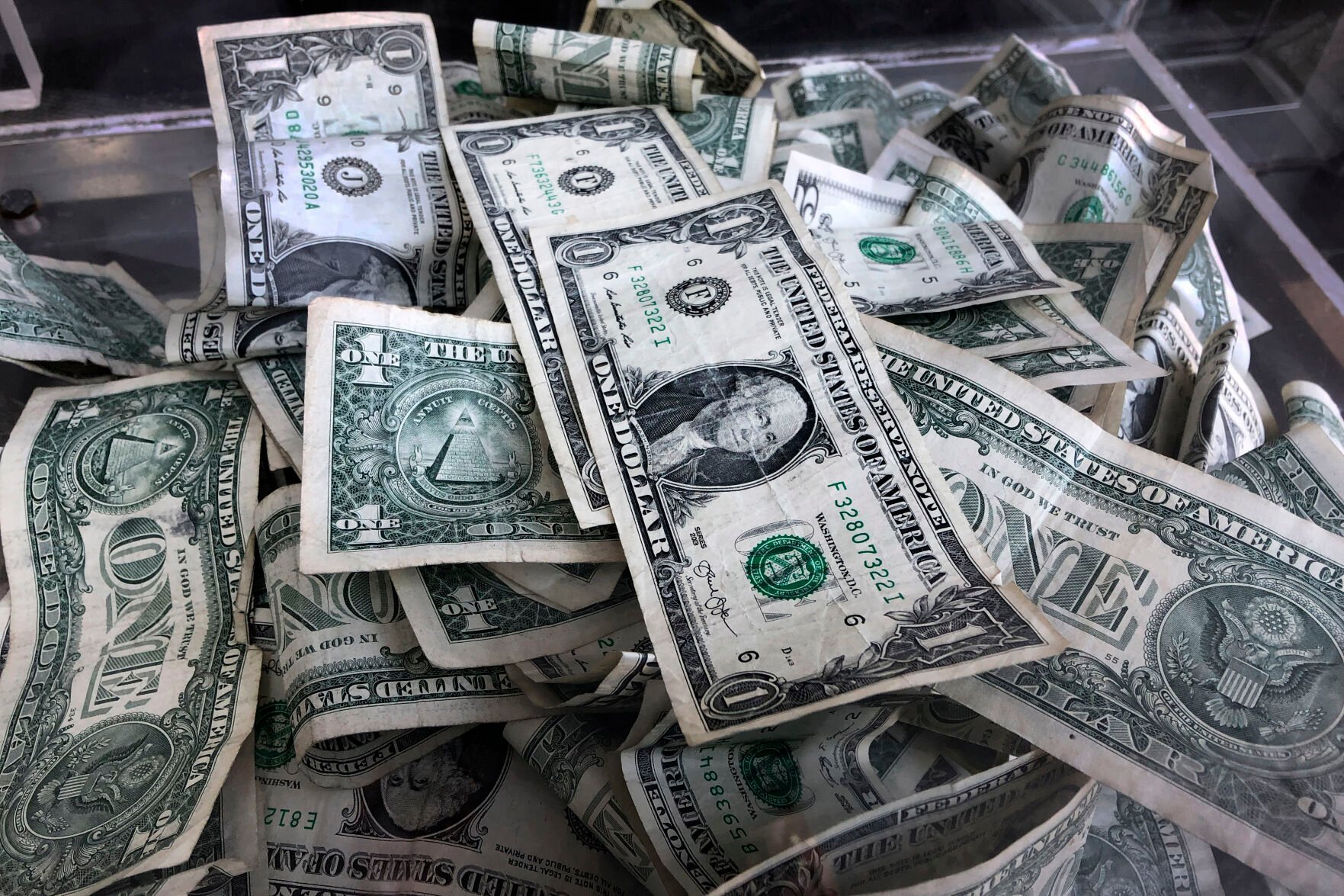 <p>FILE - In this April 3, 2019, file photo a tip box is filled with U.S. currency in New York. Deciding how to prioritize different savings goals can be overwhelming, but financial experts recommend ordering them by urgency. Most people need an emergency fund first, followed by other goals such as saving enough for retirement, buying a home, traveling, saving for college and paying off debt. (AP Photo/Mark Lennihan, File)</p>