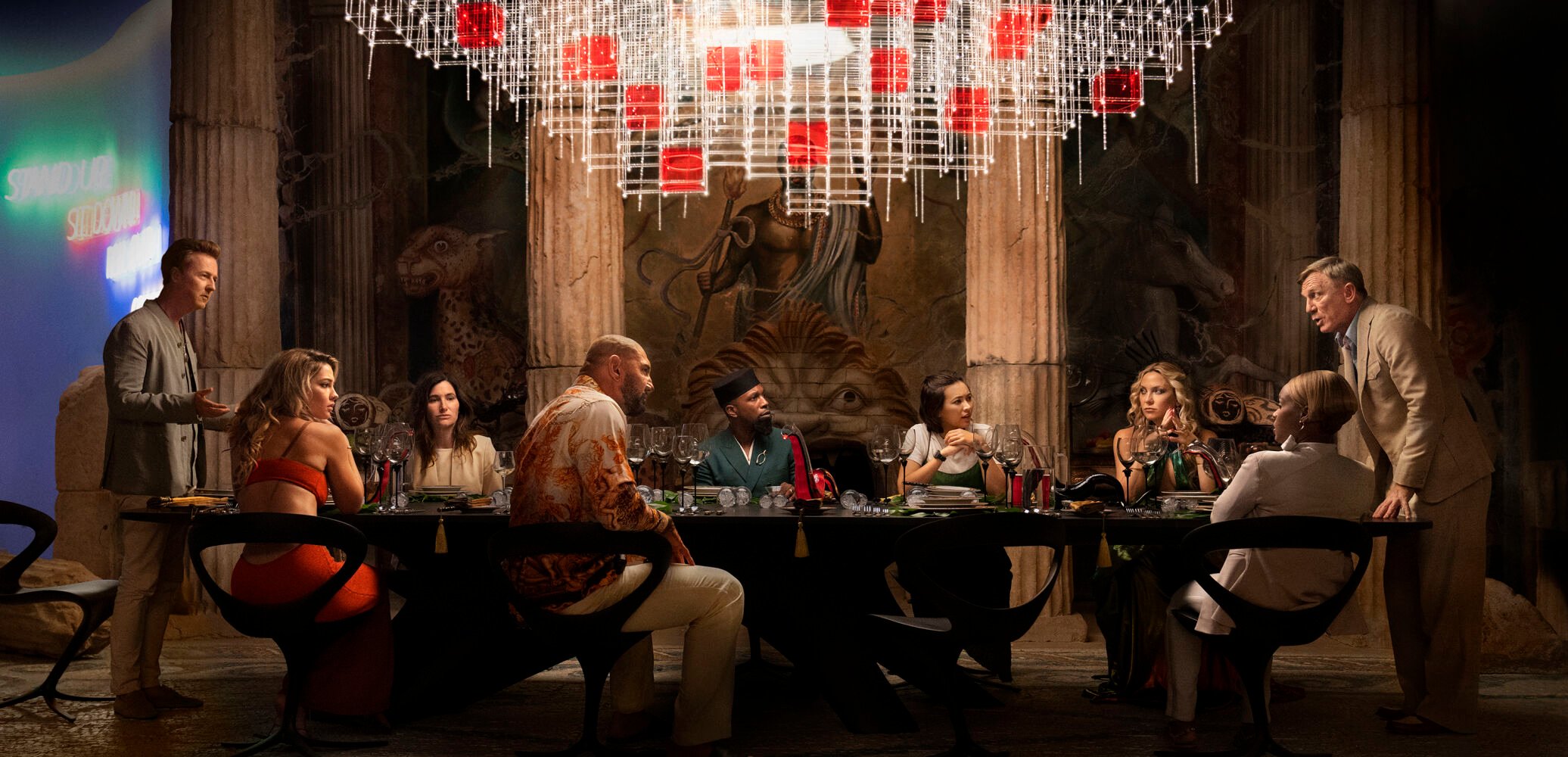 <p>This image released by Netflix shows, from left, Edward Norton, Madelyn Cline, Kathryn Hahn, Dave Bautista, Leslie Odom Jr., Jessica Henwick, Kate Hudson, Janelle Monae, and Daniel Craig in a scene from "Glass Onion: A Knives Out Mystery." (Netflix via AP)</p>