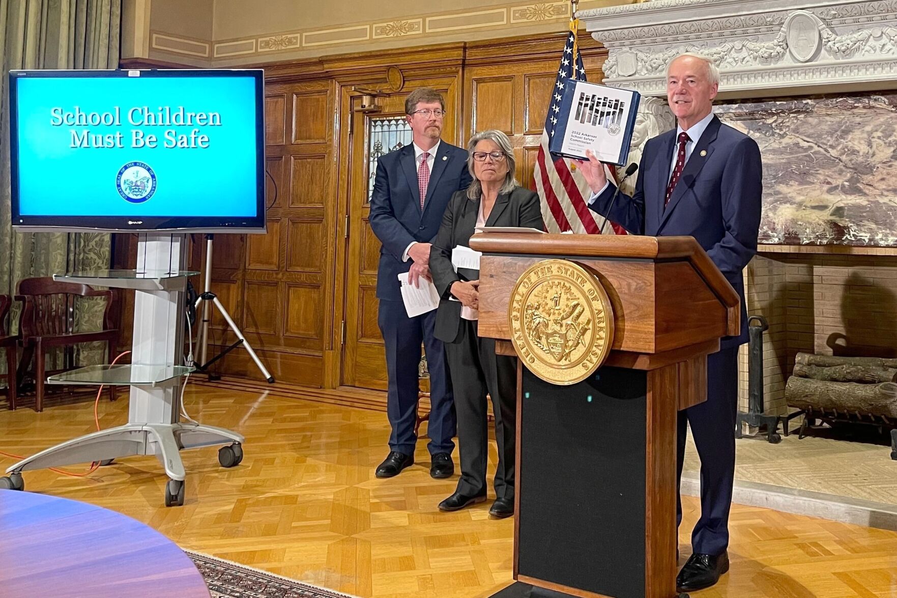 <p>FILE - Arkansas Gov. Asa Hutchinson holds up an interim report from a commission formed to review school safety measures at a news conference at the state Capitol in Little Rock, Ark., Tuesday, Aug. 2, 2022. </p>