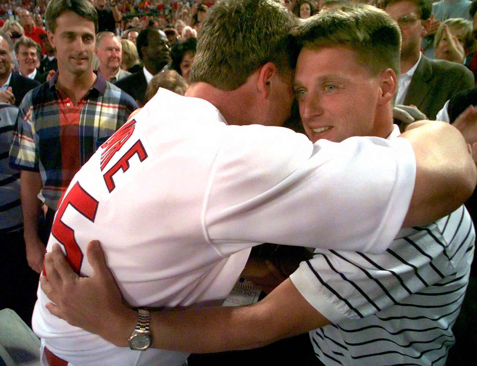 <p>St. Louis Cardinals slugger Mark McGwire hugs Richard Maris, son of the late baseball great Roger Maris, after hitting his record-breaking 62nd home run of the season off Chicago Cubs pitcher Steve Trachsel during the fourth inning in St. Louis in this Sept. 8, 1998 photo. At left is Roger Maris Jr.</p>