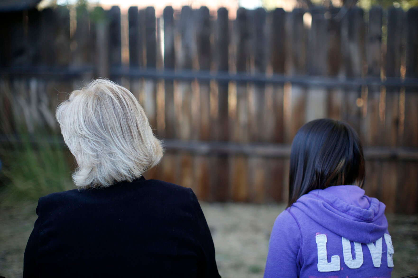 <p>FILE- MJ and her adoptive mother sit for an interview in Sierra Vista, Ariz., Oct. 27, 2021. State authorities placed MJ in foster care after learning that her father, the late Paul Adams, sexually assaulted her and posted video of the assaults on the Internet. (AP Photo/Dario Lopez-Mills, File)</p>