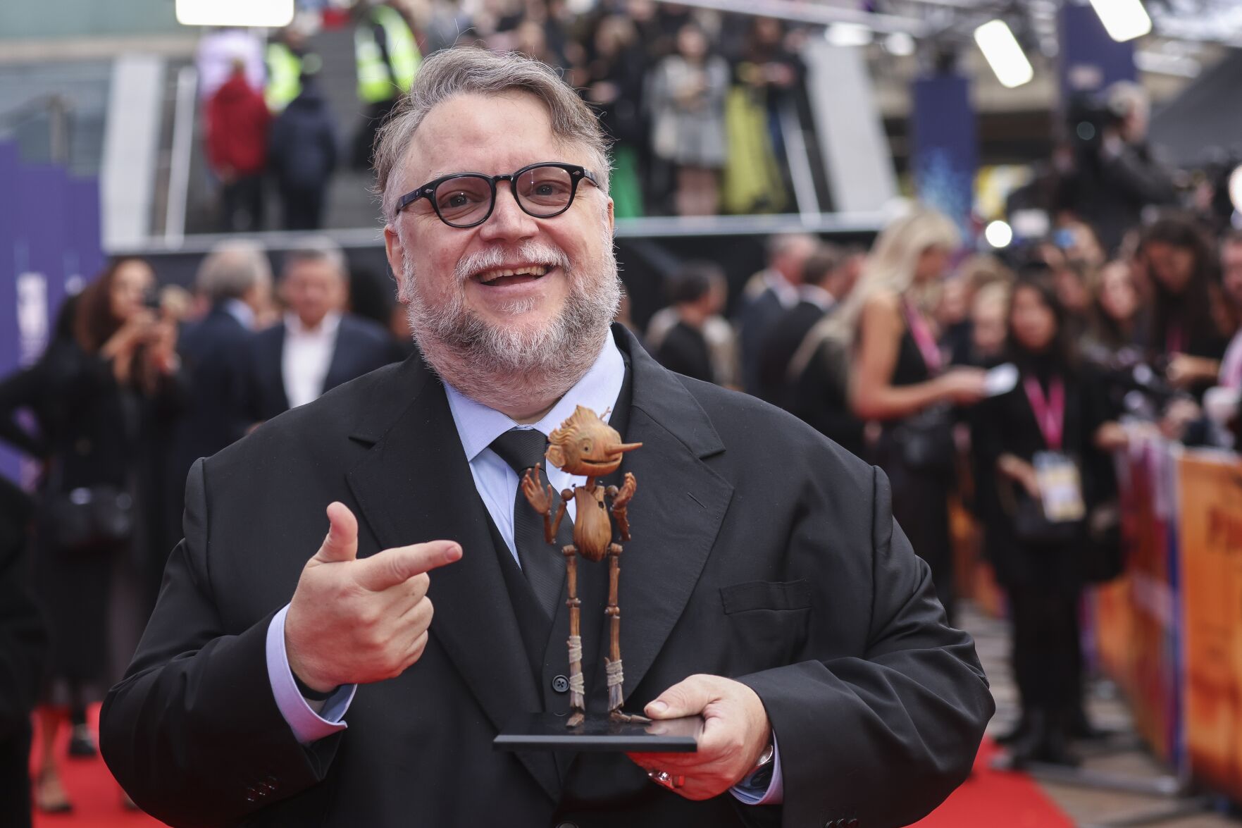 <p>Director Guillermo del Toro poses, with a model of the character Pinocchio, for photographers upon arrival for the premiere of the film 'Guillermo del Toro's Pinocchio' during the 2022 London Film Festival in London, Saturday, Oct. 15, 2022. (Photo by Vianney Le Caer/Invision/AP)</p>