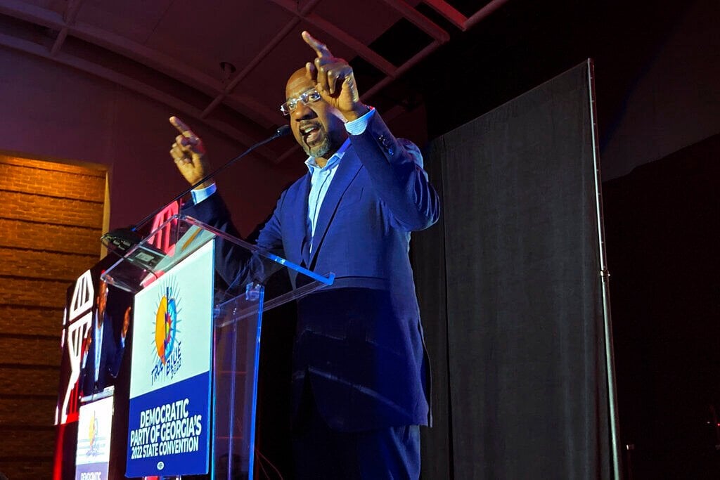 <p>Democratic U.S. Sen. Raphael Warnock exhorts the crowd on Saturday, Aug. 27, 2022 at the Democratic Party of Georgia convention in Columbus, Ga. Warnock is seeking reelection to a full six-year term in November against candidates including Republican Herschel Walker. </p>