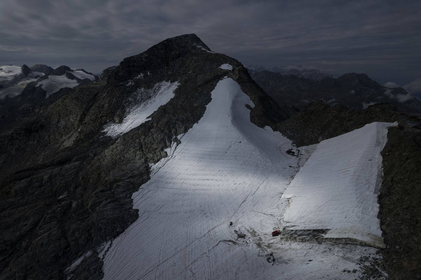 <p>FILE --Parts of the ice of the Corvatsch glacier are covered with a tarpaulin, near Samedan, Switzerland, Monday, Sept. 5, 2022. Glaciologists have stopped their program to measure the glacier. The decision has already been taken in 2019 and the hot summer of 2022 has led to "extreme losses of ice" and the end of the program. The covered part of the glacier is used as a ski slope in winter. (Gian Ehrenzeller/Keystone via AP,file)</p>