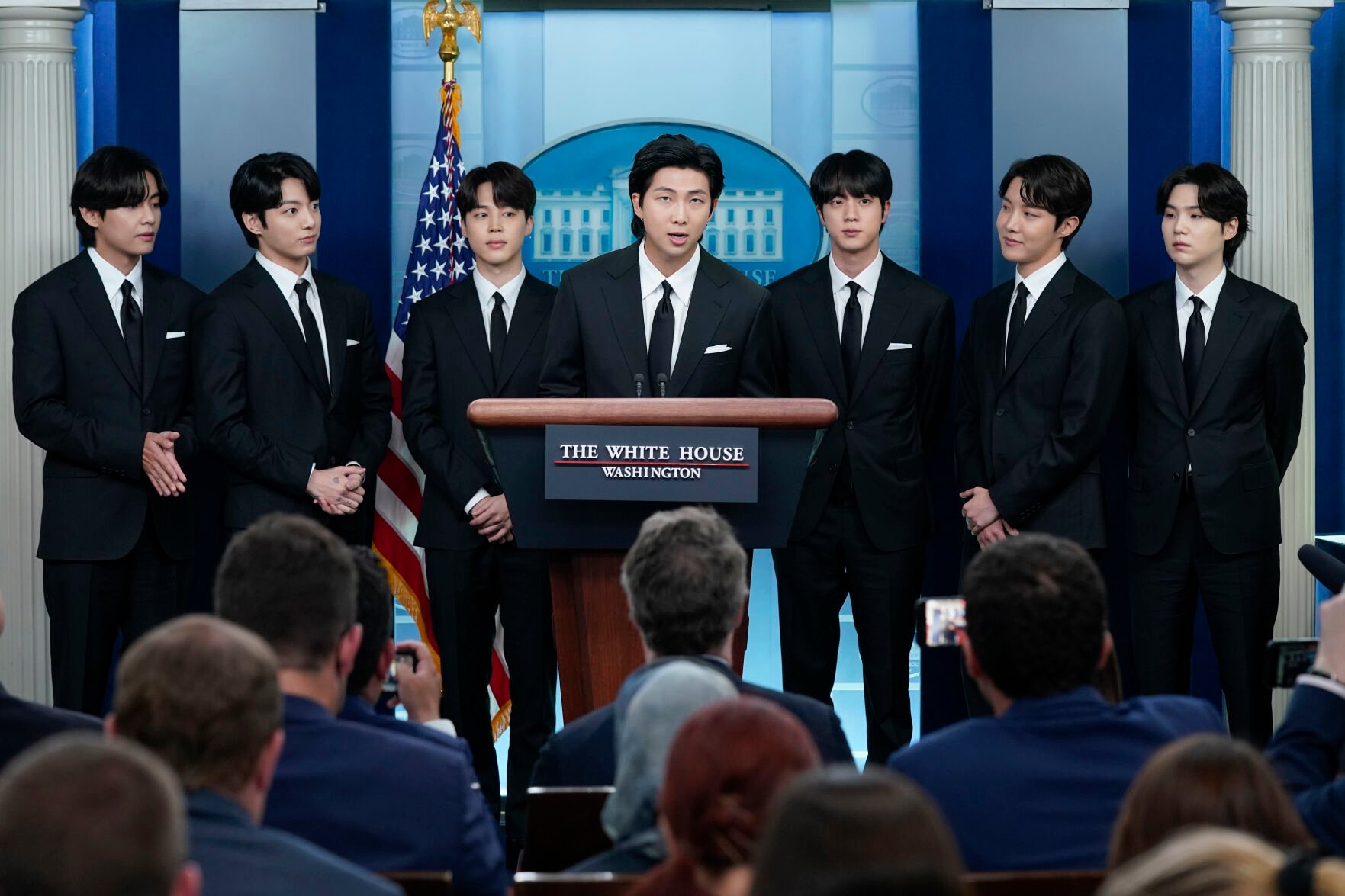 <p>FILE - RM, center, accompanied by other K-pop supergroup BTS members from left, V, Jungkook, Jimin, Jin, J-Hope, and Suga speaks during the daily briefing at the White House in Washington, Tuesday, May 31, 2022. The members of K-pop band BTS will serve their mandatory military duties under South Korean law, their management company said Monday, Oct. 17, 2022, effectively ending a debate on exempting them because of their artistic accomplishments.</p>