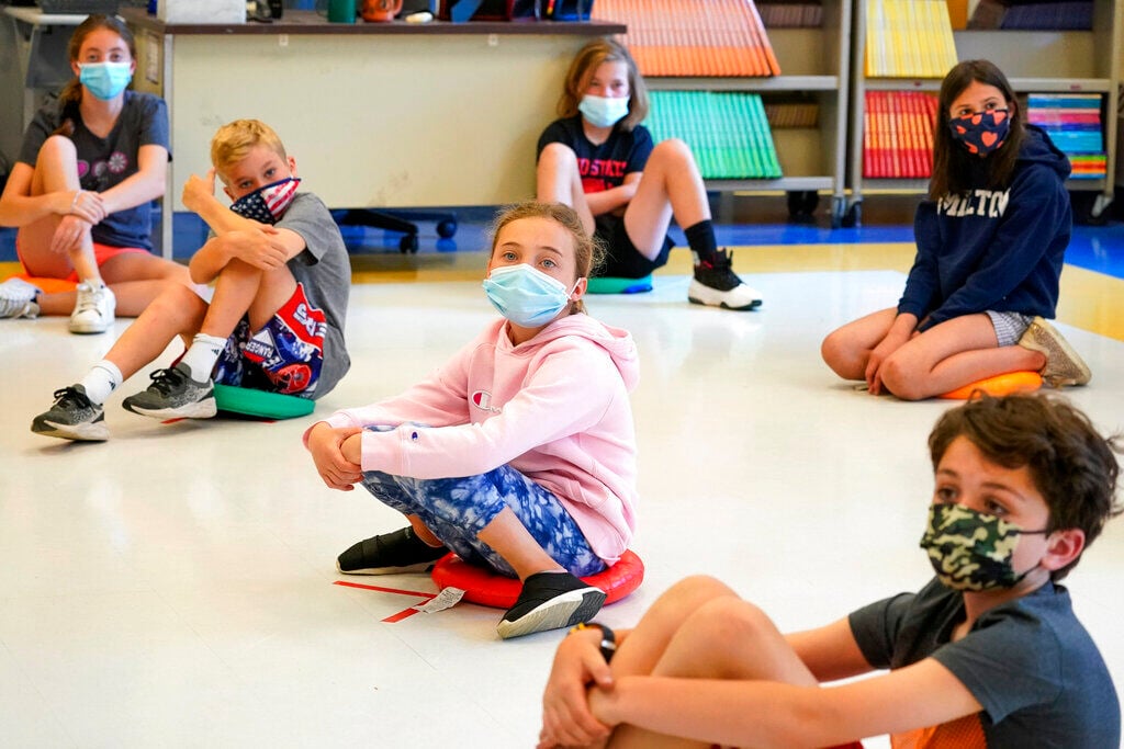 <p>FILE - Fifth graders wearing face masks sit at proper social distancing during a music class at the Milton Elementary School in Rye, N.Y., May 18, 2021. </p>