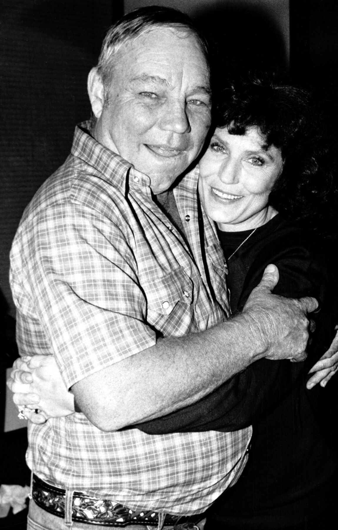<p>FILE - Country music singer Loretta Lynn embraces her husband, Oliver "Mooney" Lynn, during rehearsal for her New York debut, on Oct. 21, 1982. </p>