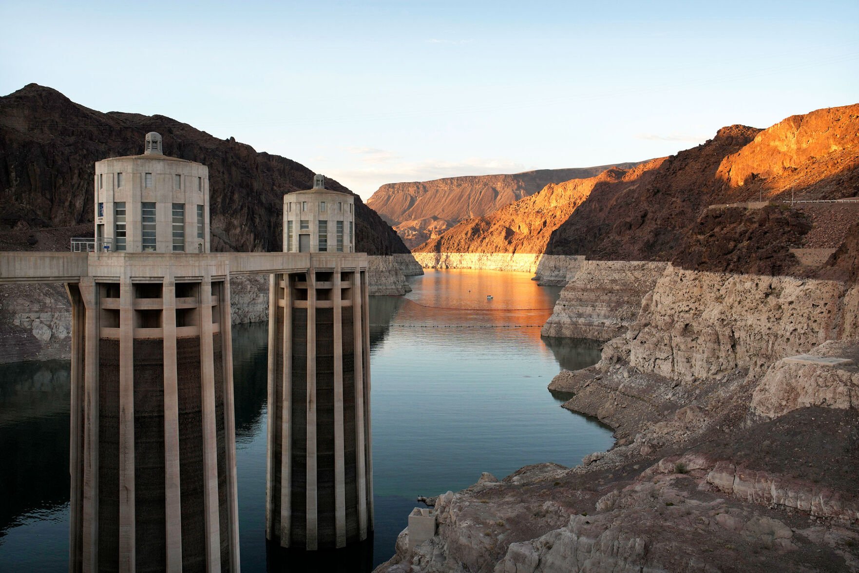 <p>A bathtub ring of light minerals shows the water line of Lake Mead near water intakes on the Arizona side of Hoover Dam on June 26, 2022, near Boulder City, Nev.</p>