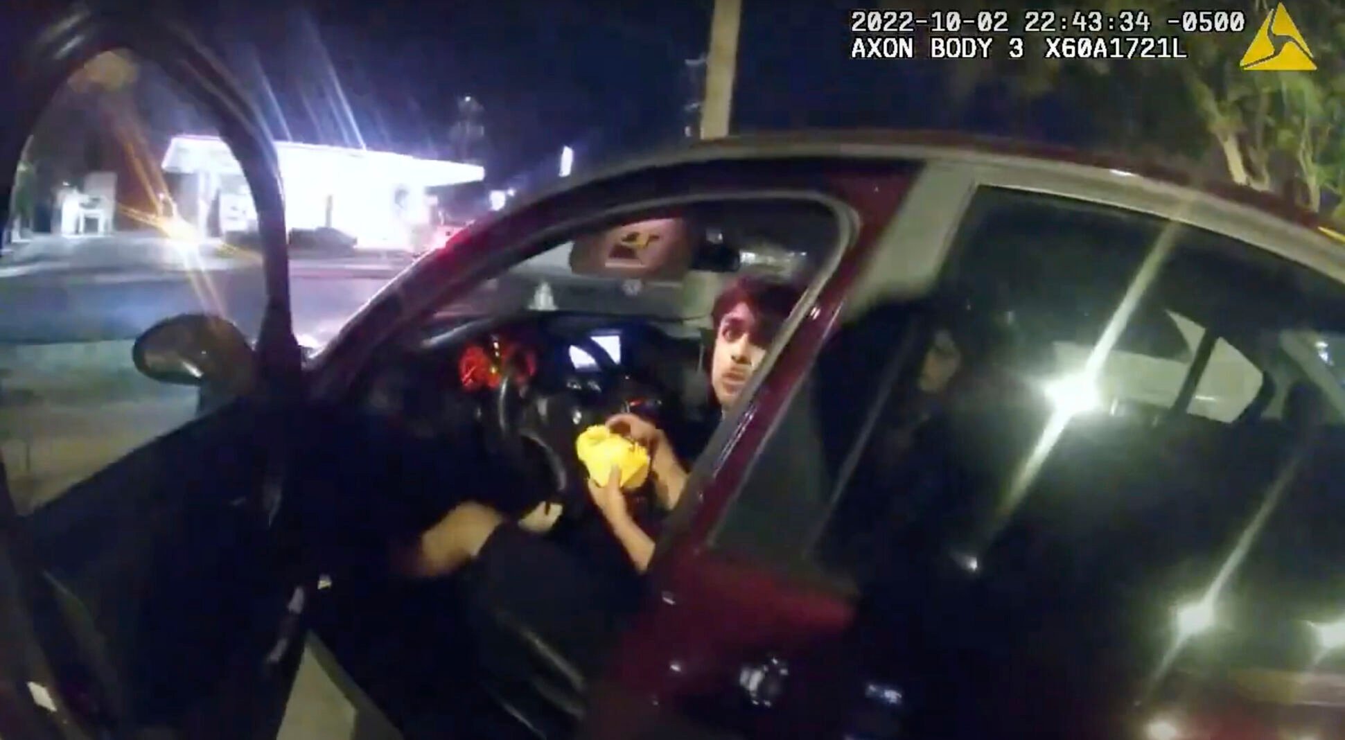 <p>In this image taken from Oct. 2, 2022 police body camera video and released by San Antonio Police Department, Erik Cantu looks toward San Antonio Police officer James Brennand while holding a hamburger in a fast food restaurant parking lot as the officer opens the car door in San Antonio, Texas. Brennand opened fire several times wounding the unarmed teenager as he drove away. Brennand was fired after the shooting, police training commander Alyssa Campos said in a video statement released Wednesday, Oct. 5, 2022. (San Antonio Police Department via AP)</p>