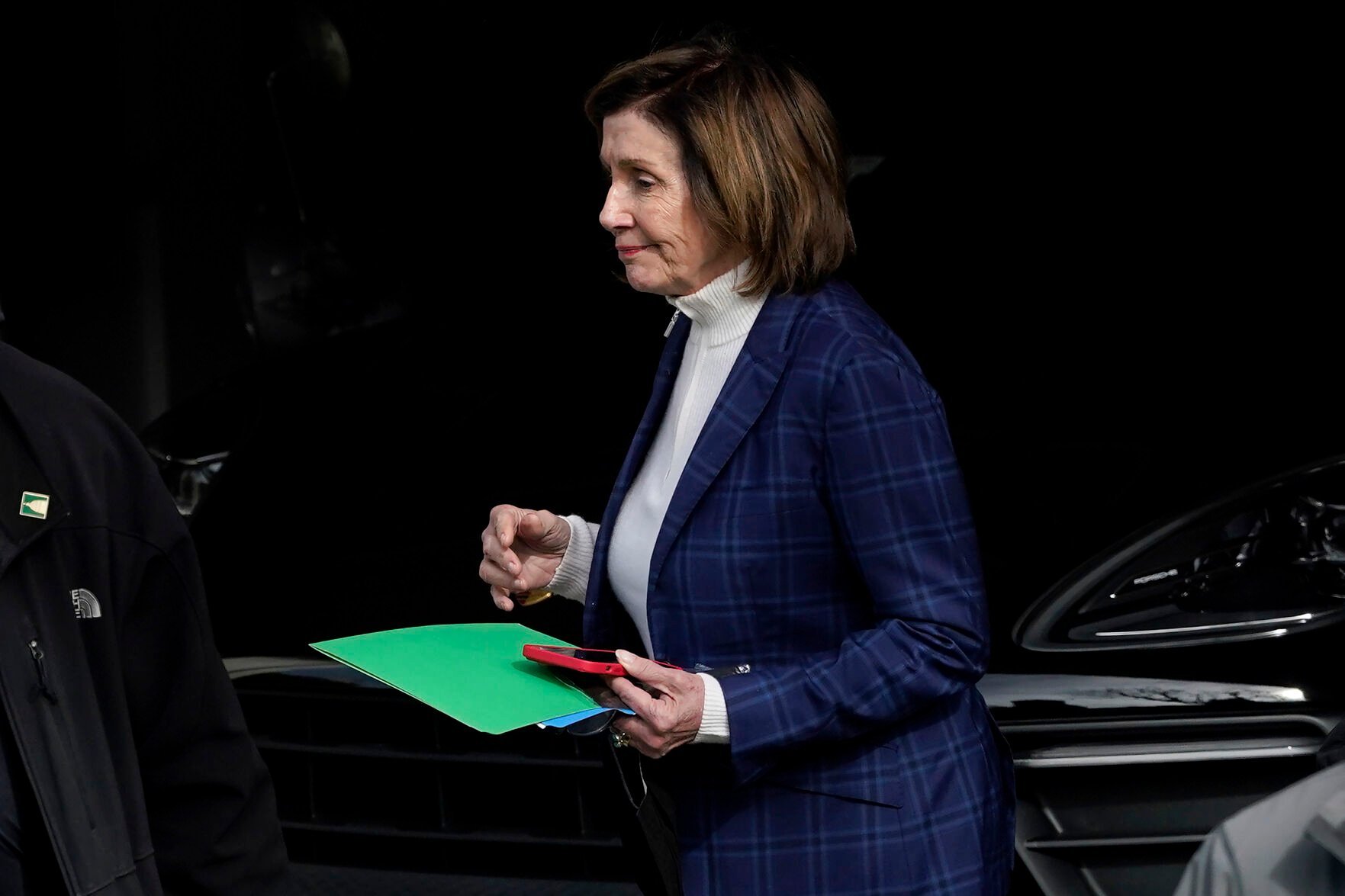 <p>House Speaker Nancy Pelosi is escorted to a vehicle outside of her home in San Francisco on Friday.</p>