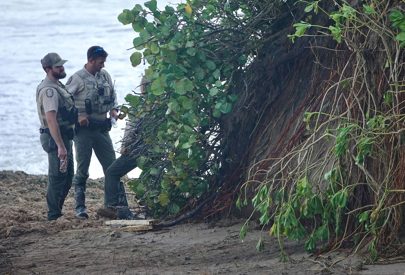 <p>Florida Fish and Wildlife Conservation Commission employees guard the area where ancient human remains were uncovered Thursday by the surf of Hurricane Nicole on Chastain Beach in Stuart, Fla.</p>