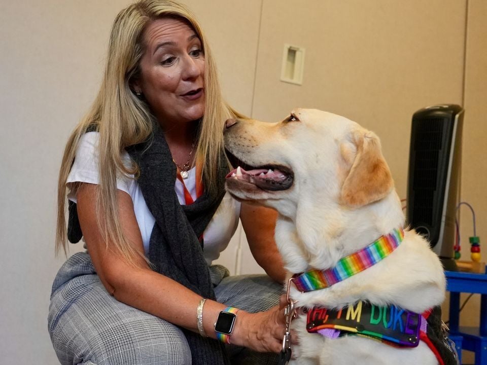 <p>Danielle Santilli and her therapy dog, Duke, visit an urgent mental health center. Duke is the first facility-based therapy dog for the Oregon Department of Human Services.</p>
