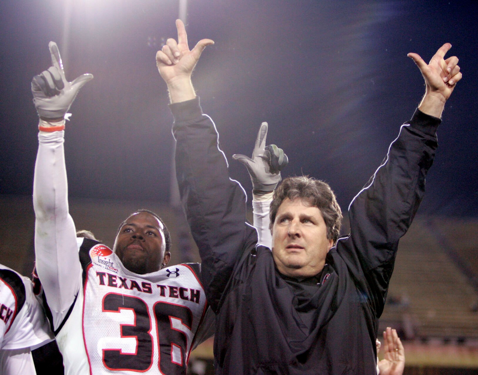 <p>Texas Tech's Antonio Huffman (36) and coach Mike Leach, right, celebrate after Texas Tech defeated Minnesota 44-41 in overtime in the Insight Bowl college football game Friday, Dec. 29, 2006, at Sun Devil Stadium in Tempe, Ariz. </p>