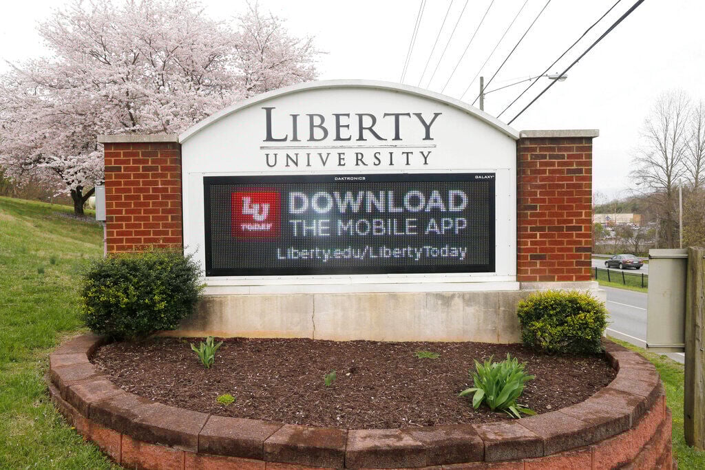 <p>FILE - A sign that marks an entrance to Liberty University, is pictured on March, 24, 2020, as students were welcomed back to the campus during the coronavirus outbreak in Lynchburg, Va. </p>