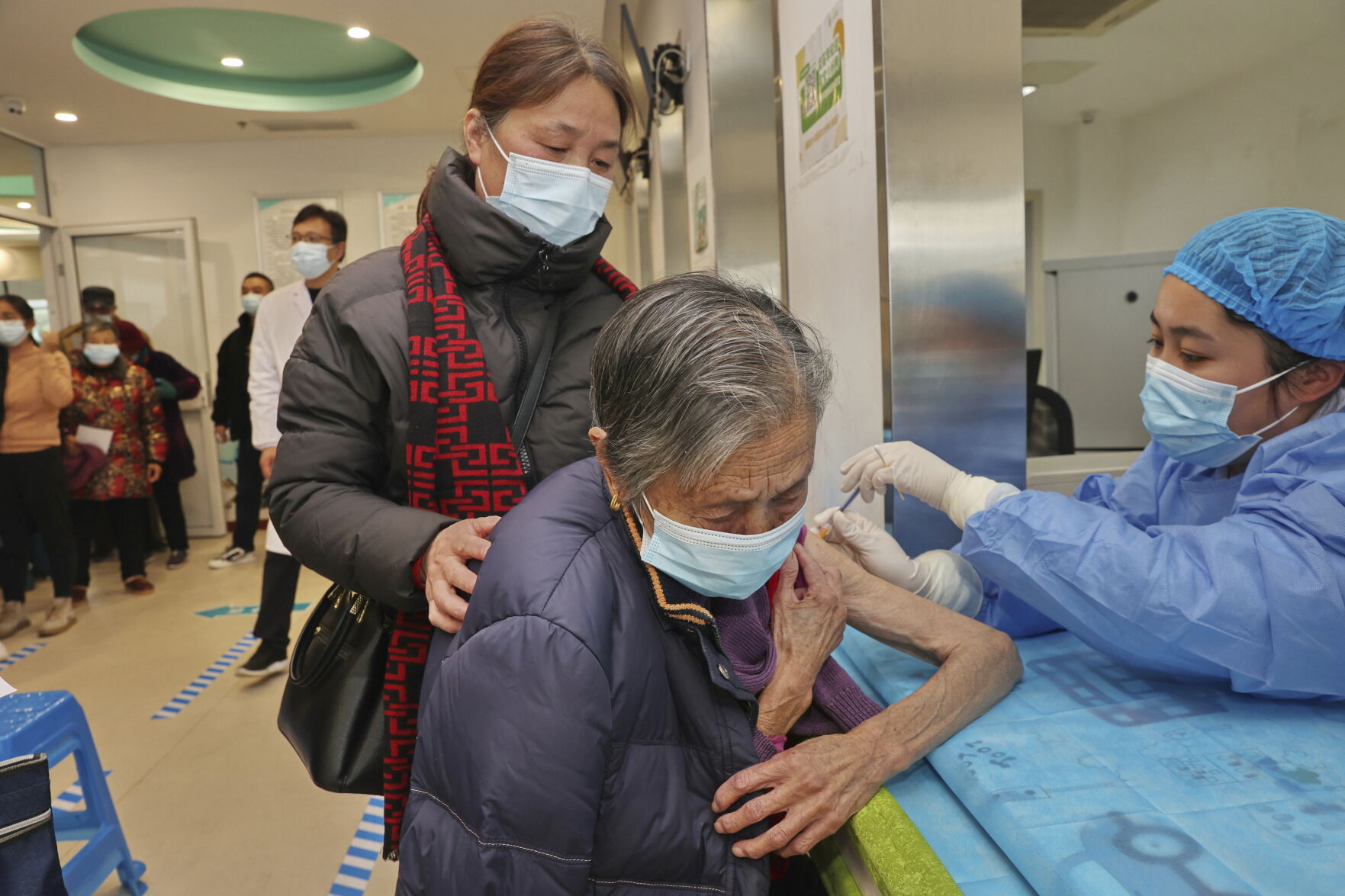 <p>A nurse gives a COVID-19 vaccine shot to an elderly woman Dec. 9 at a community health center in Nantong in eastern China's Jiangsu province.</p>