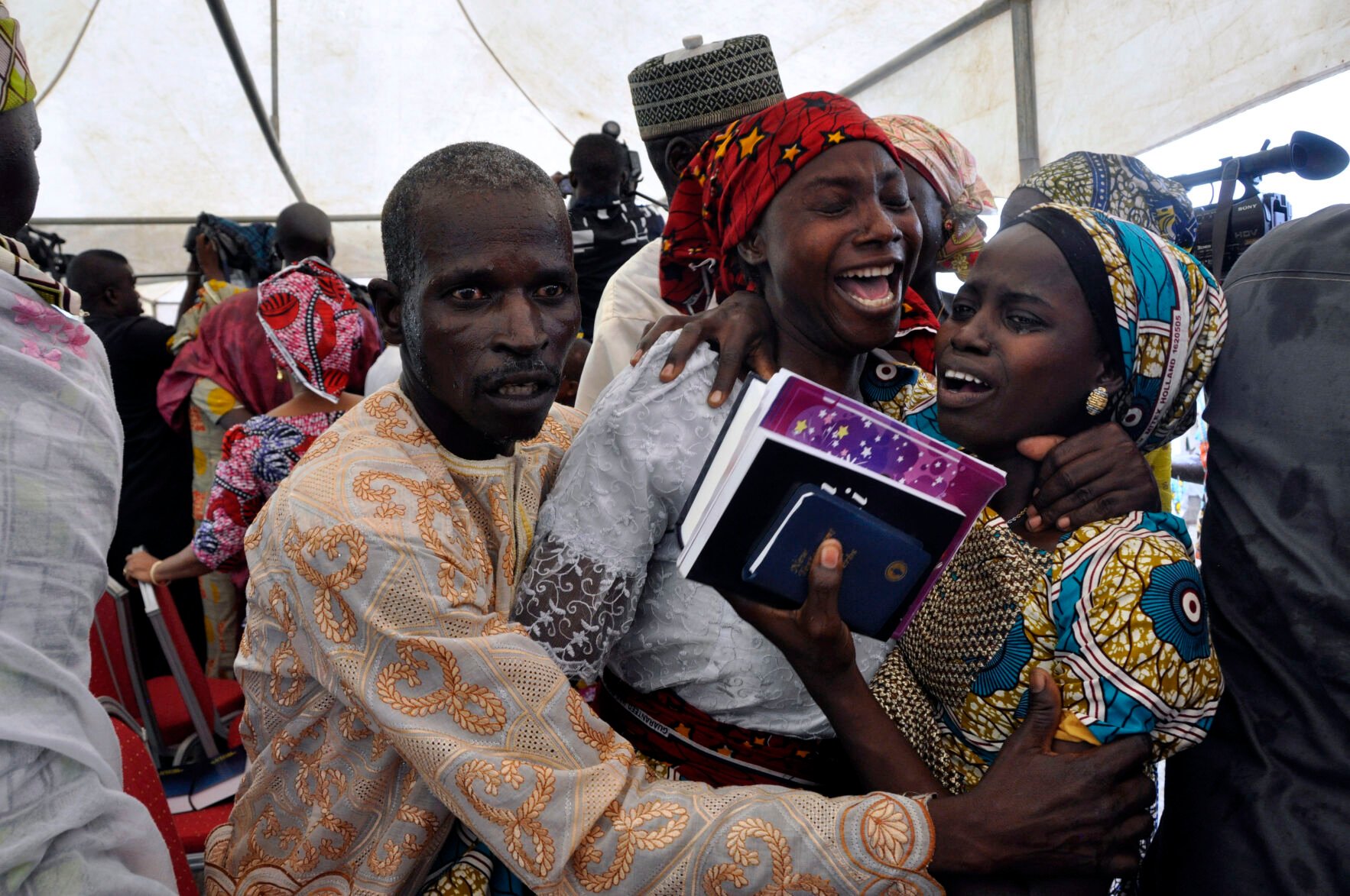 <p>A girl who was kidnapped by Boko Haram extremists celebrates with family members after her release with others, during a church service held on Oct. 16, 2016, in Abuja, Nigeria.</p>