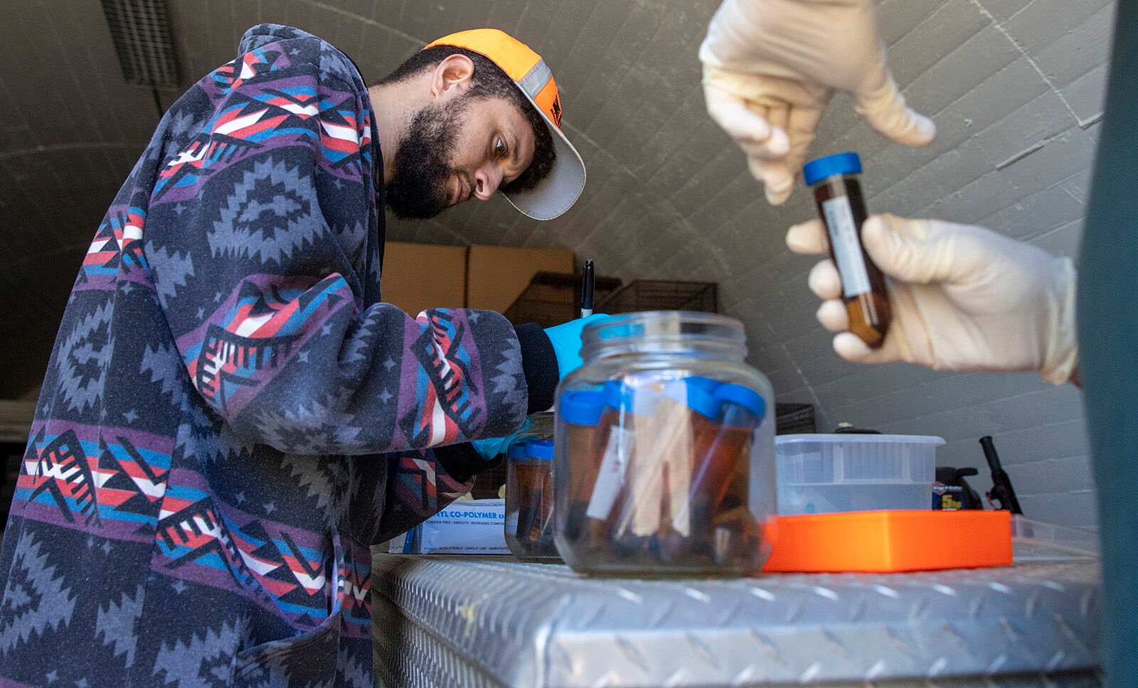 <p>U.S. Geological Survey biologist Jared Heath, left, works works with Robert Fisher to extract drops of ethanol from vials containing invertebrates, part of Fisher's 25-year collection inside a WWII munitions bunker on the former El Toro Marine Corp Air Station on Wednesday, Dec. 14, 2022, in Irvine, California. (Brian van der Brug/Los Angeles Times/TNS)</p>