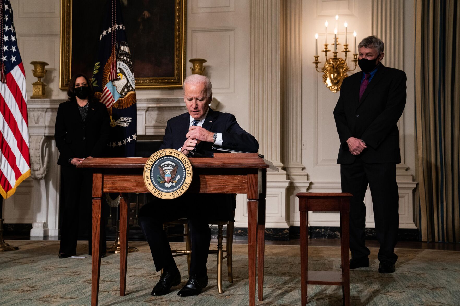 <p>President Joe Biden signs executive orders after speaking about climate change issues Jan. 27, 2021, in the White House in Washington.</p>