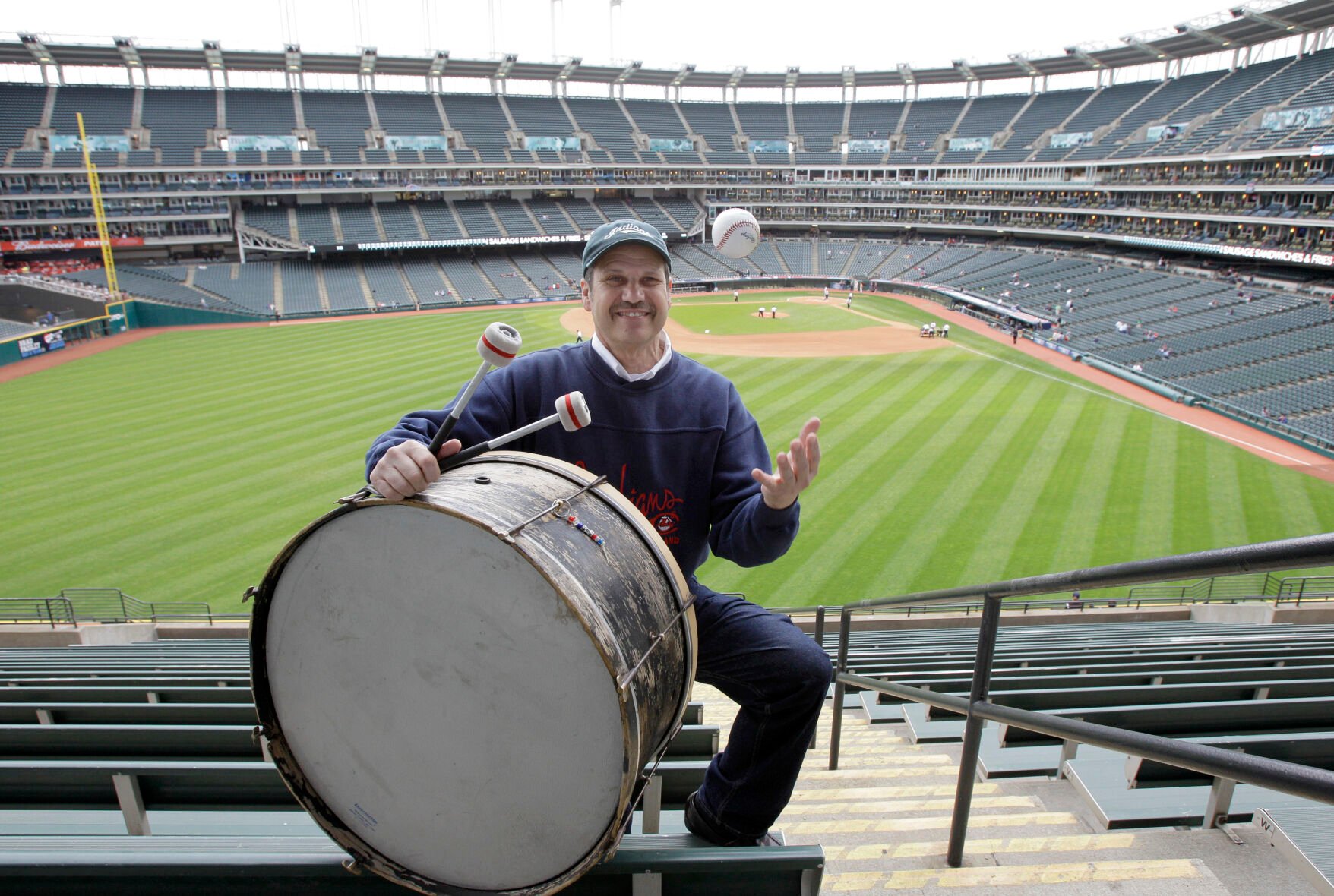 <p>Cleveland Indians fan John Adams poses in his usual centerfield bleacher seat in 2011 with his ever-present bass drum before a game against Kansas City Royals in Cleveland.</p>