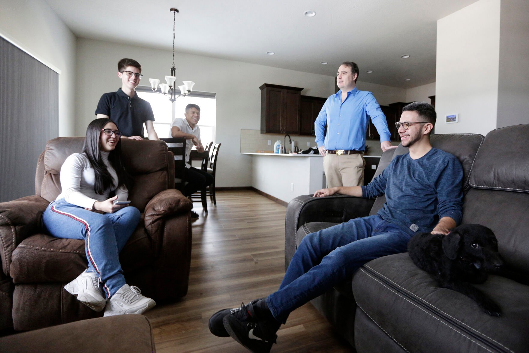 <p>Dr. Kyle Varner, second from the right, who sponsors and houses people through the Venezuelan humanitarian parole program, speaks at his house with program beneficiaries, from left, Maria Amare, Cesar Baez, Jenderson Rondon and Henry Nadales on Friday in Spokane, Wash.</p>