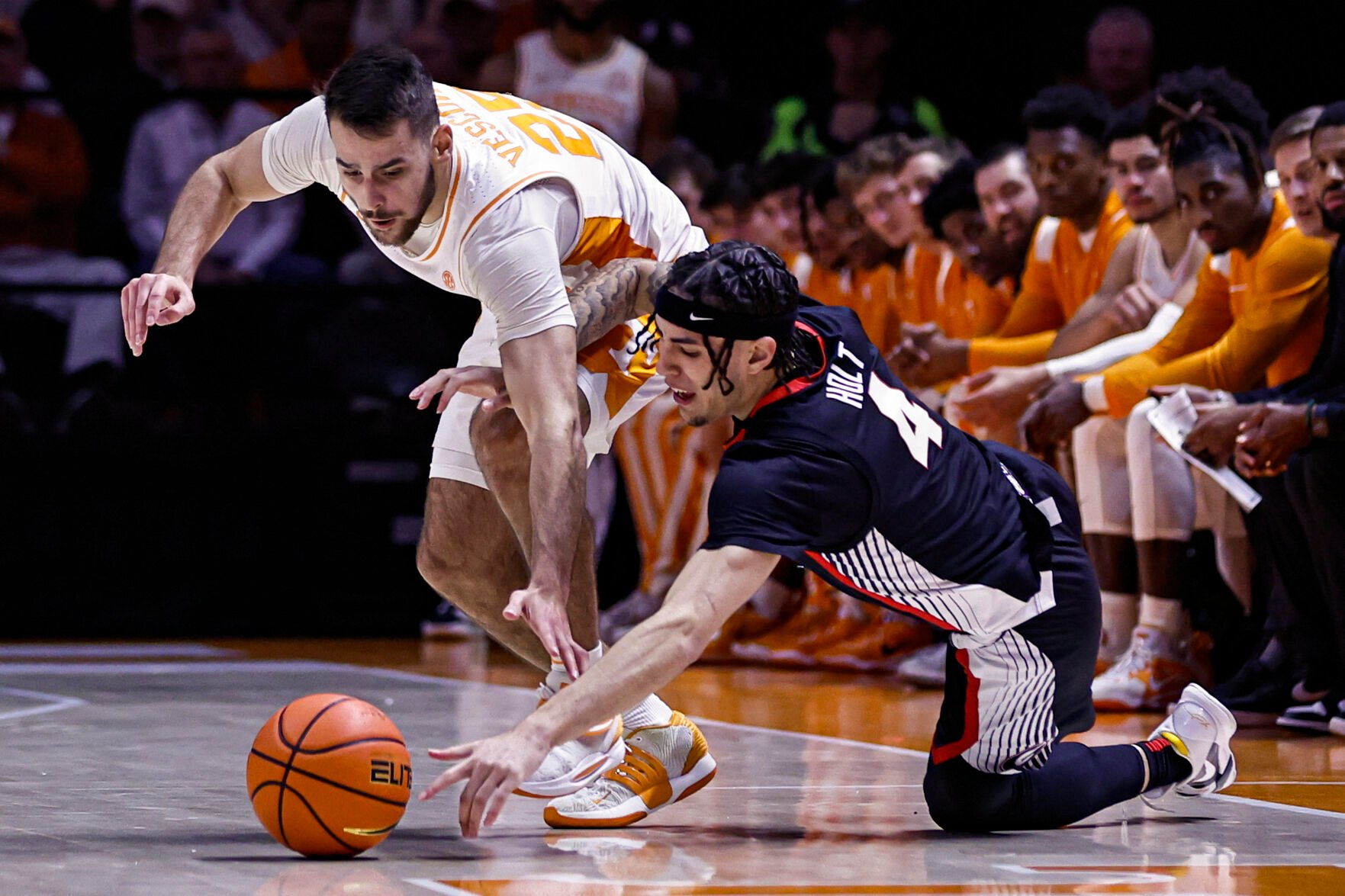 <p>Tennessee guard Santiago Vescovi and Georgia guard Jusaun Holt, right, scramble for the ball during the first half of Wednesday's game in Knoxville, Tenn.</p>