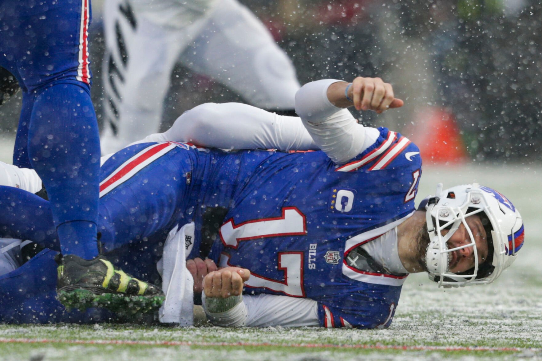 <p>Buffalo Bills quarterback Josh Allen takes a hit after making a pass against the Cincinnati Bengals during the first quarter of Sunday's AFC division round game in Orchard Park, N.Y.</p>
