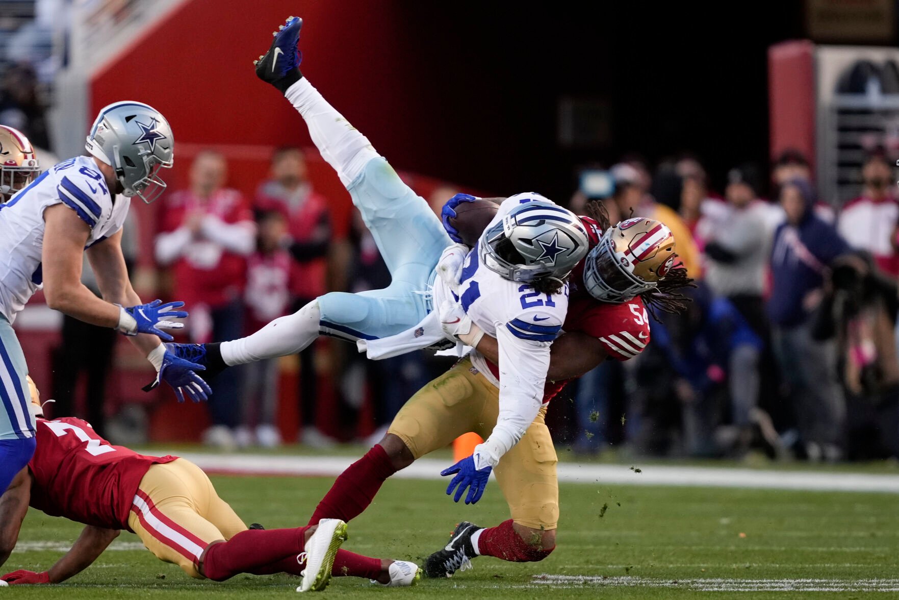 <p>Dallas Cowboys running back Ezekiel Elliott is tackled by San Francisco 49ers linebacker Fred Warner during the first half of Sunday's NFC divisional round game in Santa Clara, Calif.</p>