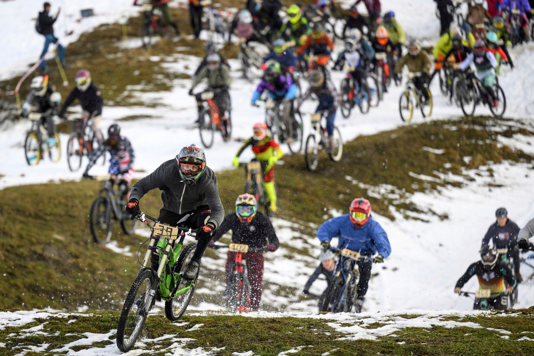<p>Cyclists, some dressed in costumes, ride their bikes on the ski slopes during the start of the 33rd edition of the "GP St-Sylvestre," a new-year snow mountain bike race, on Dec. 31, 2022, in the alpine resort of Villars-sur-Ollon, Switzerland.</p>